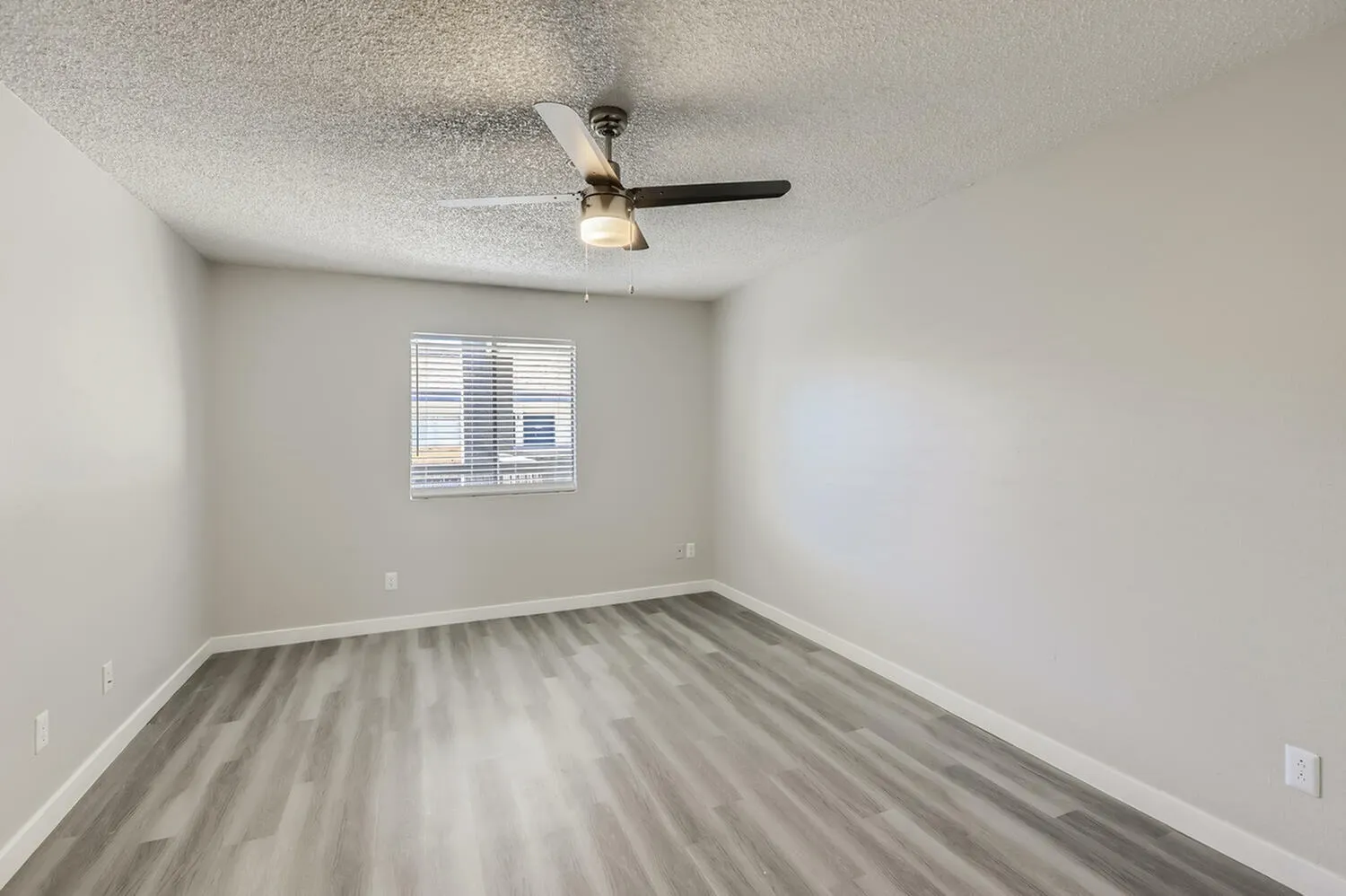 Bedroom, wood-style plank flooring, ceiling fan with light fixture, window with blinds