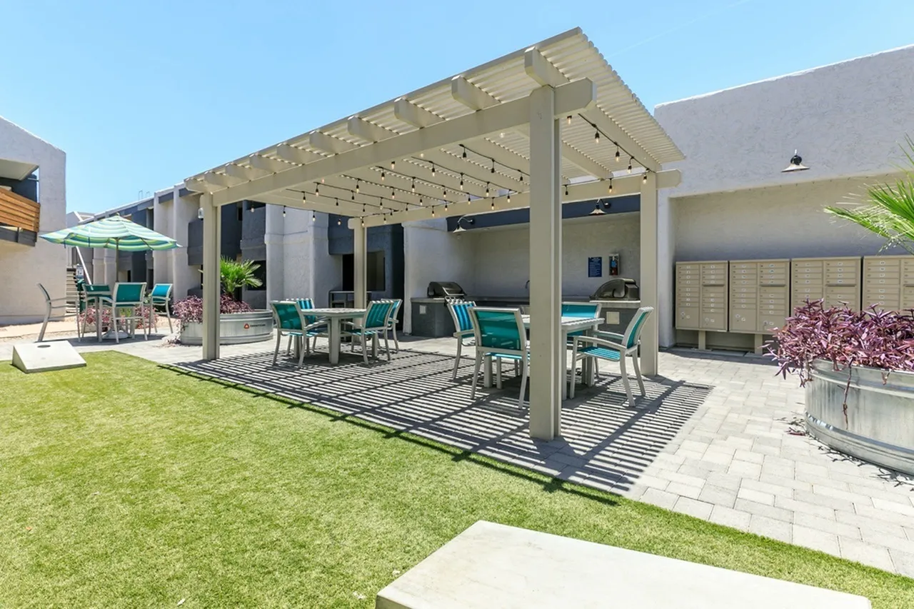 Outdoor patio, covered pergola, striped pavers, dining furniture, manicured lawn, Phoenix