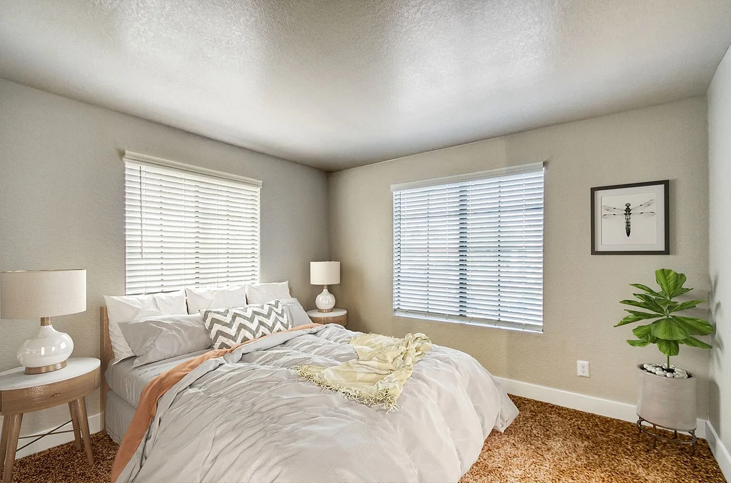 Primary bedroom, plantation shutters, wood-style plank flooring, bedside lamps, green plant