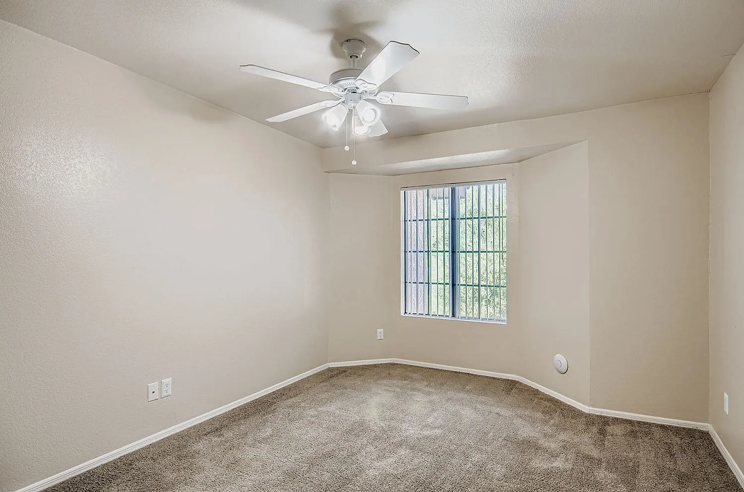 Bedroom, carpet flooring, ceiling fan with light, barred window