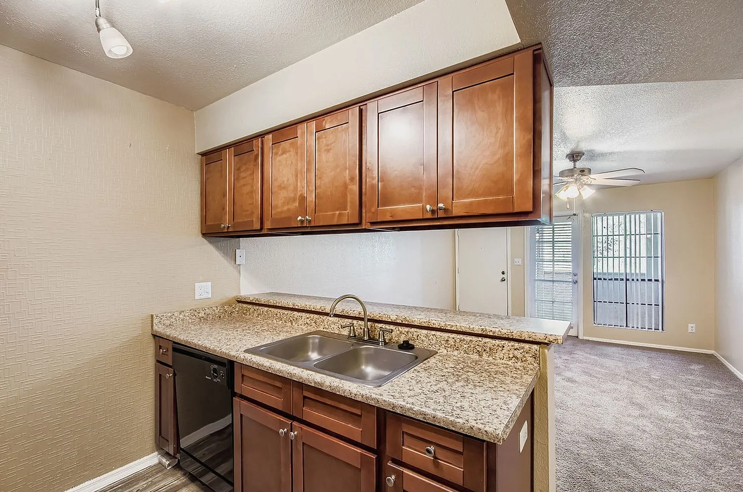 Kitchen, wood cabinetry, granite countertops, stainless sink, black dishwasher