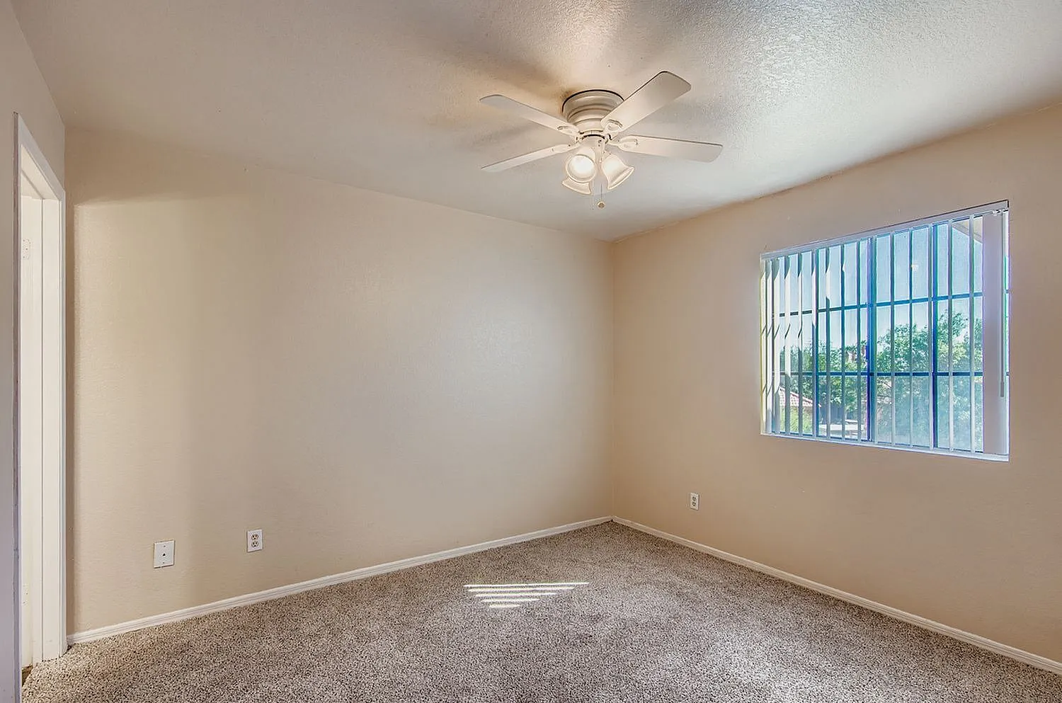 Bedroom, carpet flooring, ceiling fan with light fixture, window with vertical blinds