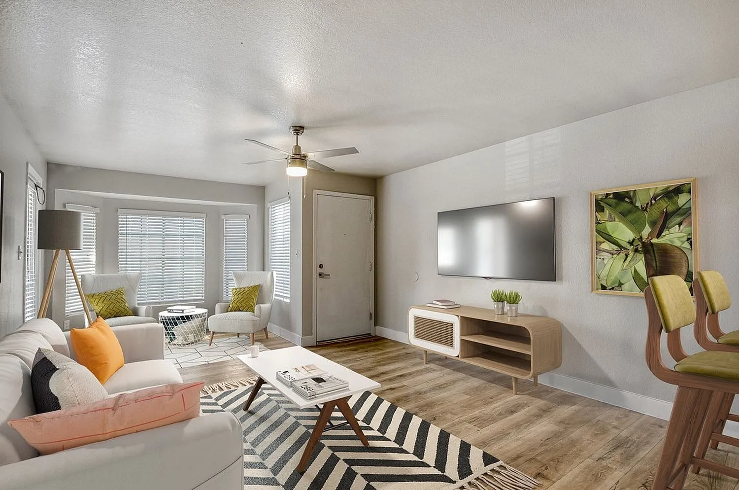 Living room with wood-style plank flooring, ceiling fan, TV, striped area rug