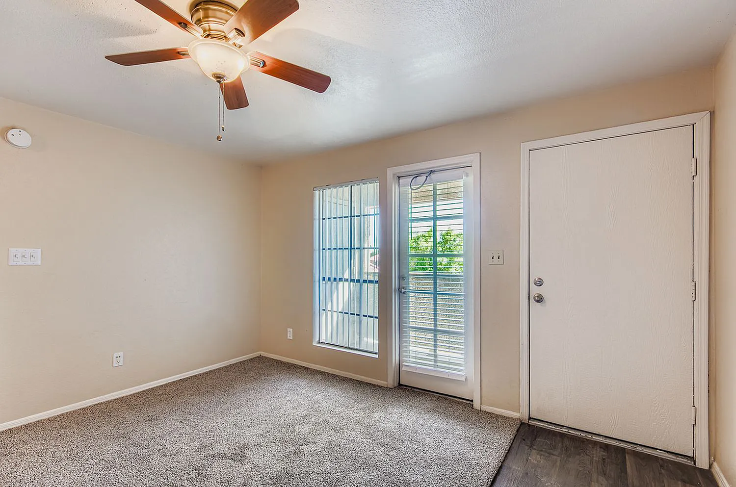 Bedroom, ceiling fan with wood blades, carpeting, sliding patio doors with shutters