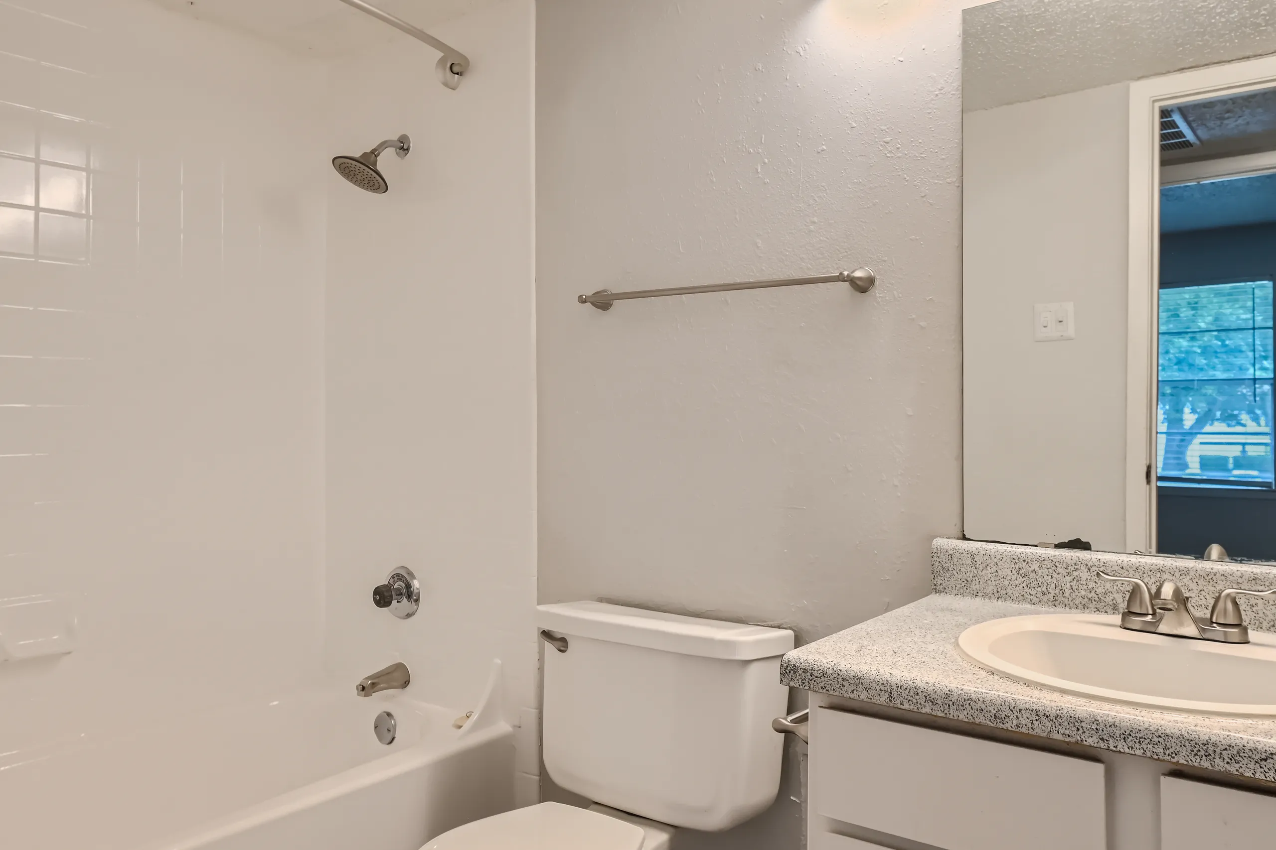 Primary bathroom with tub shower combo and vanity mirror
