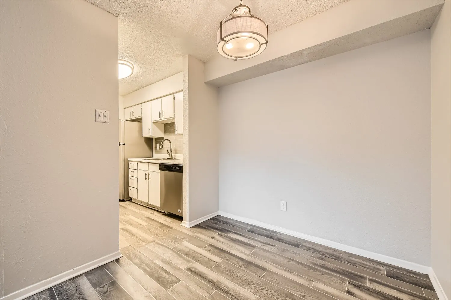Dining area with pendant light and open kitchen view