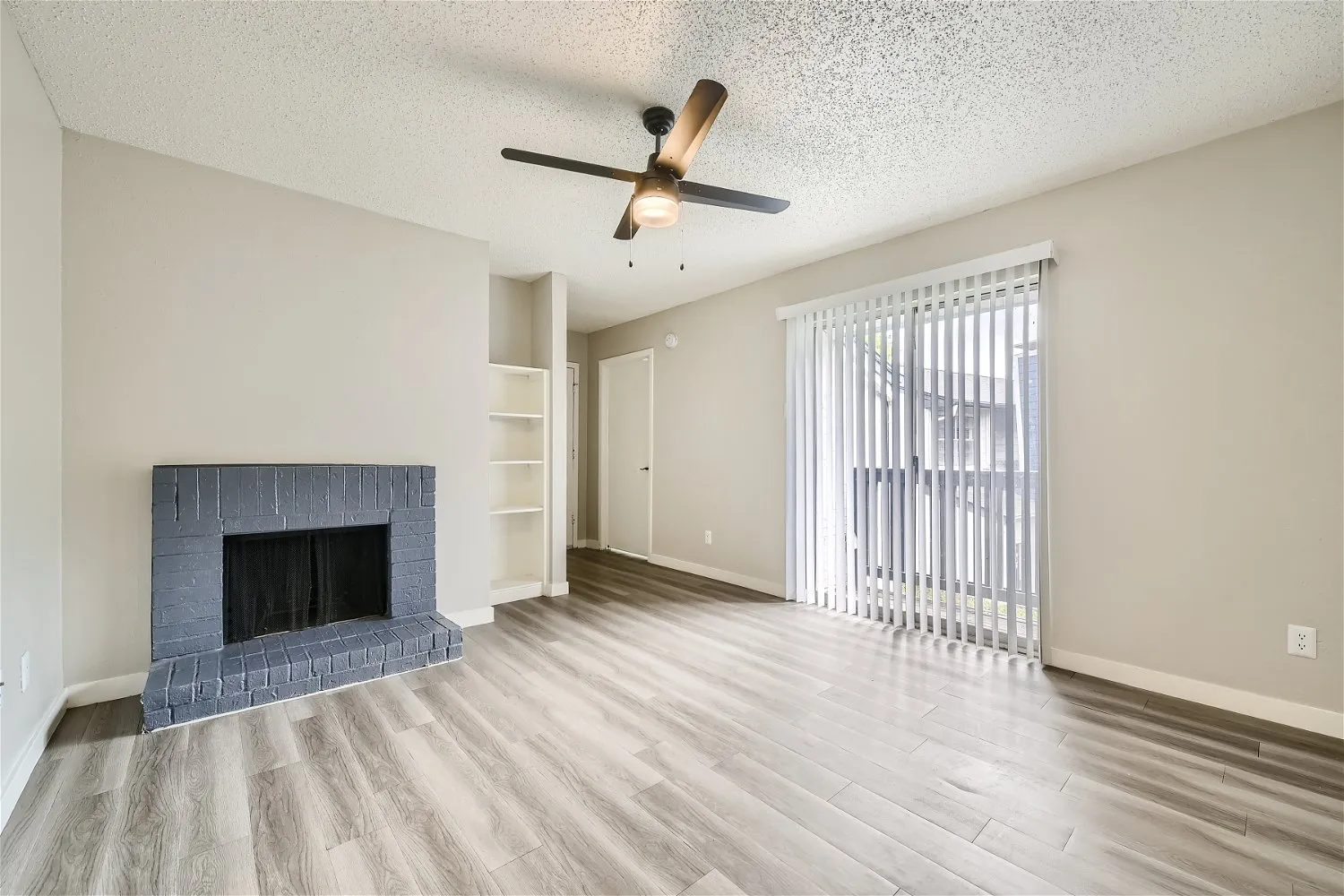 Living room with sliding glass door and built-in shelving