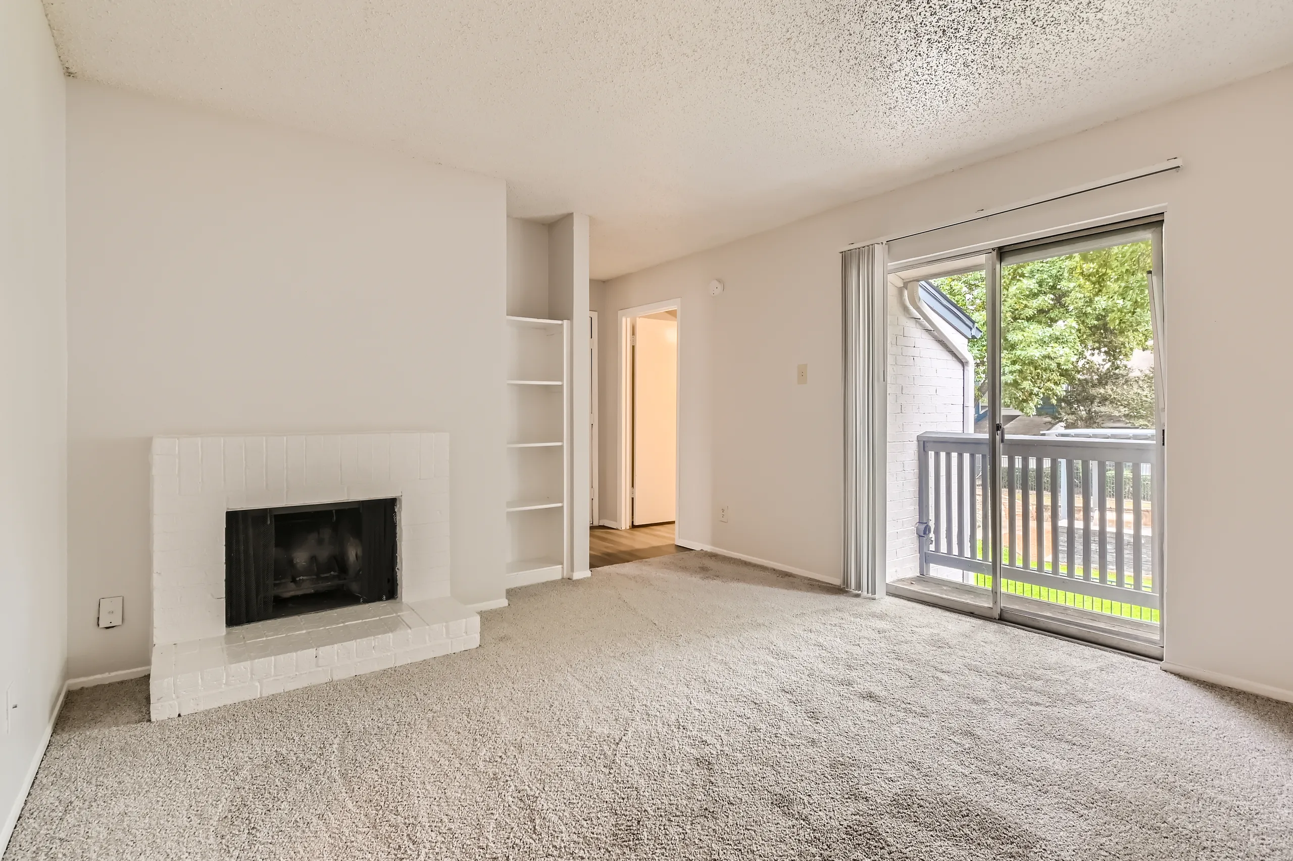 B1 Classic floor plan living room with fireplace and sliding glass door