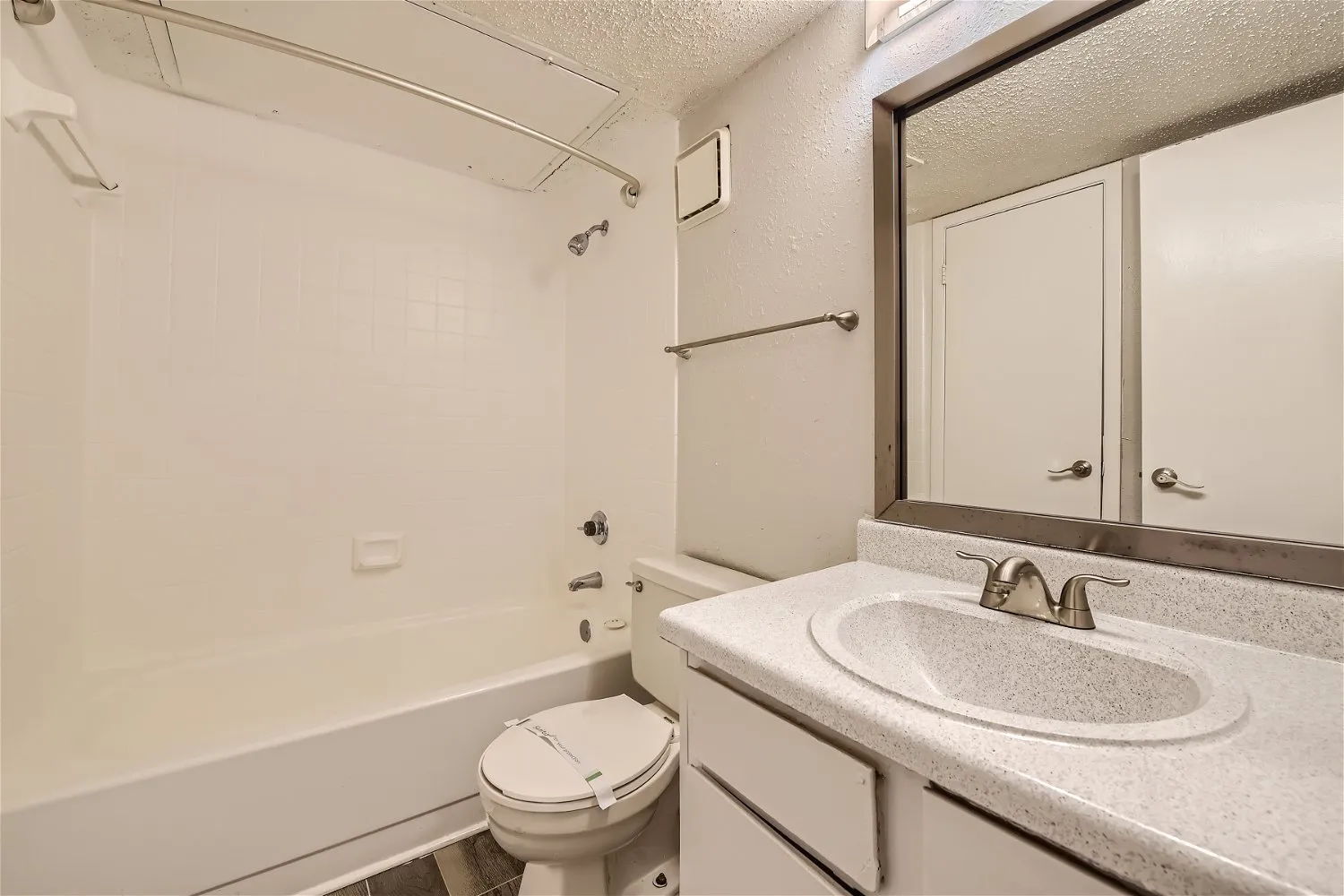 Second bathroom with tub shower combo and vanity mirror