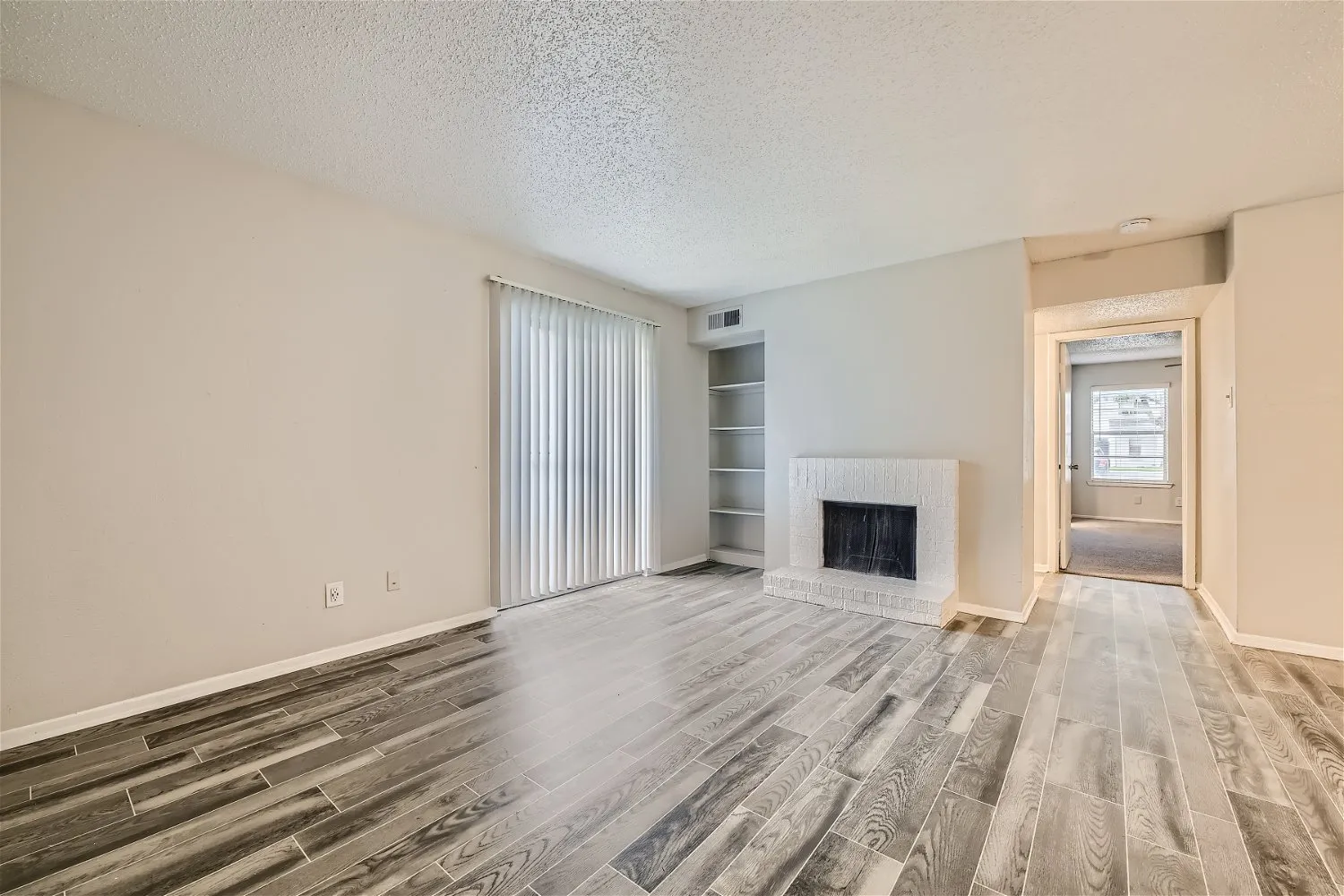 B2 Silver floor plan living room with painted brick fireplace and built-in shelving