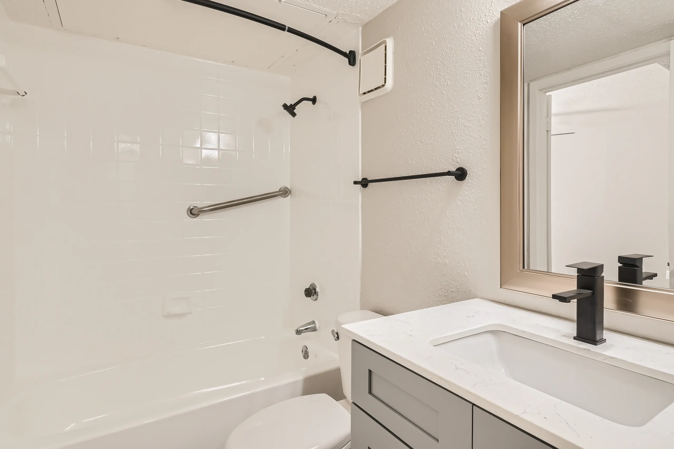 Second bathroom with tub shower combo and quartz vanity