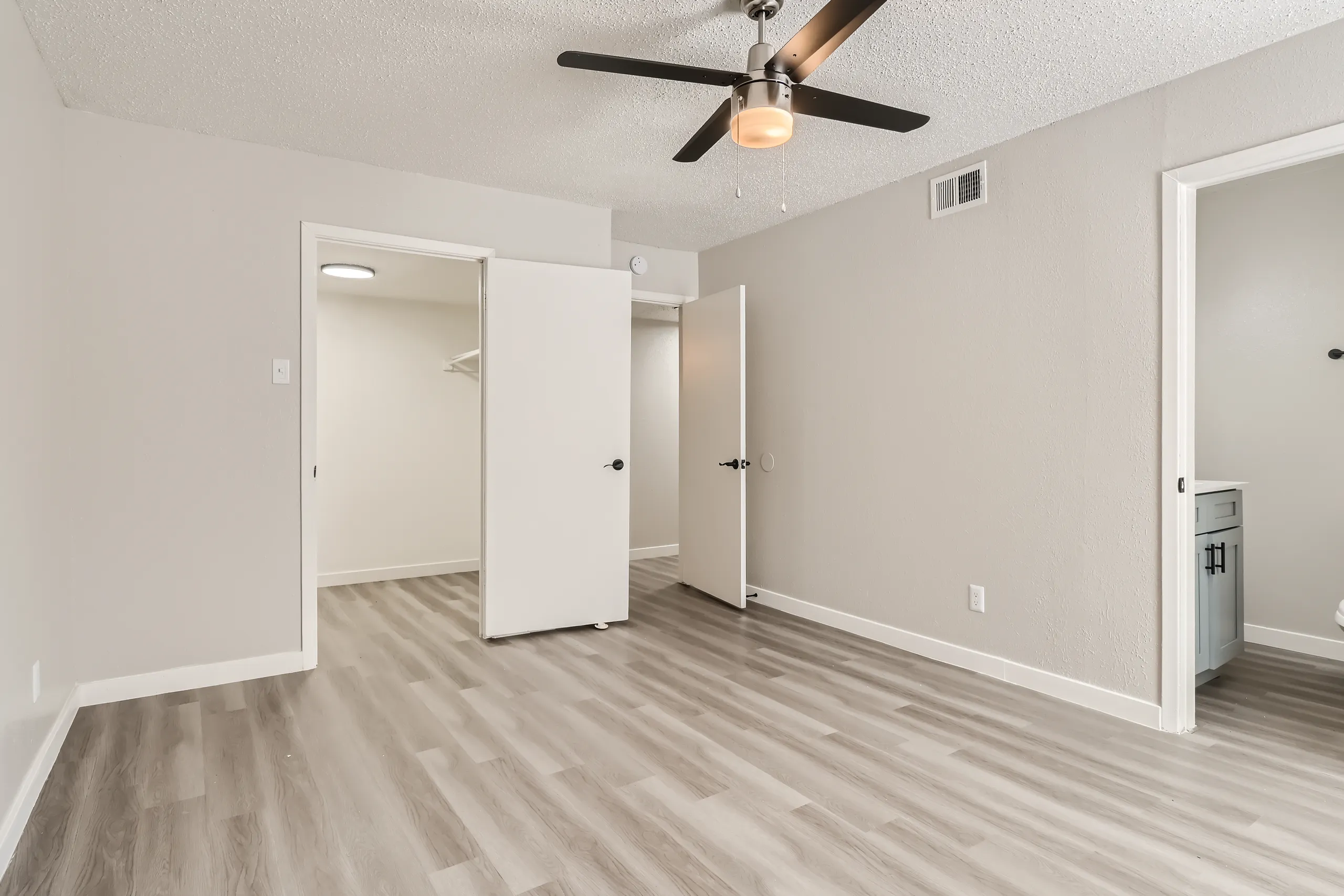 Primary bedroom with dual closets and ensuite access