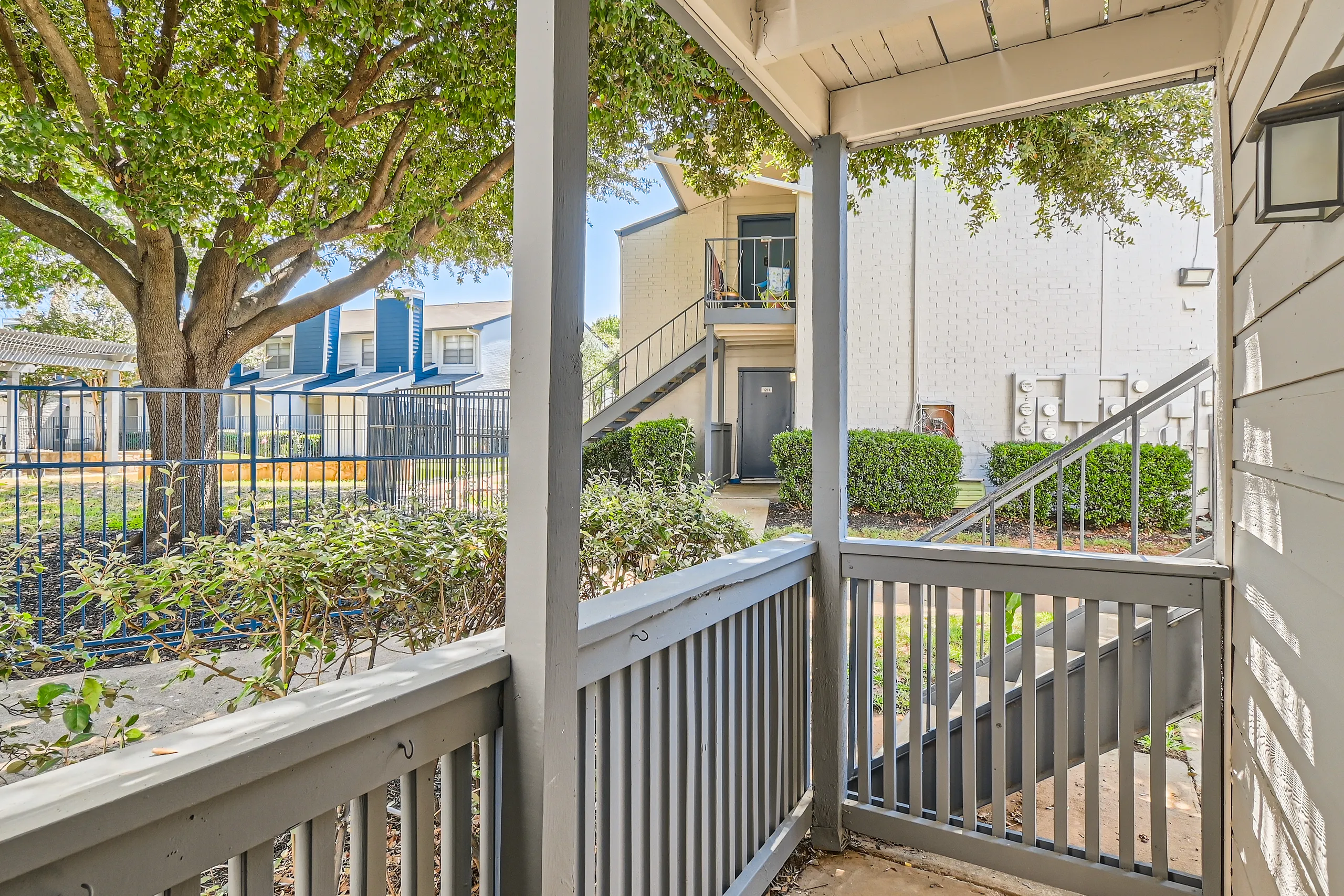 Private patio with courtyard view and mature shade tree