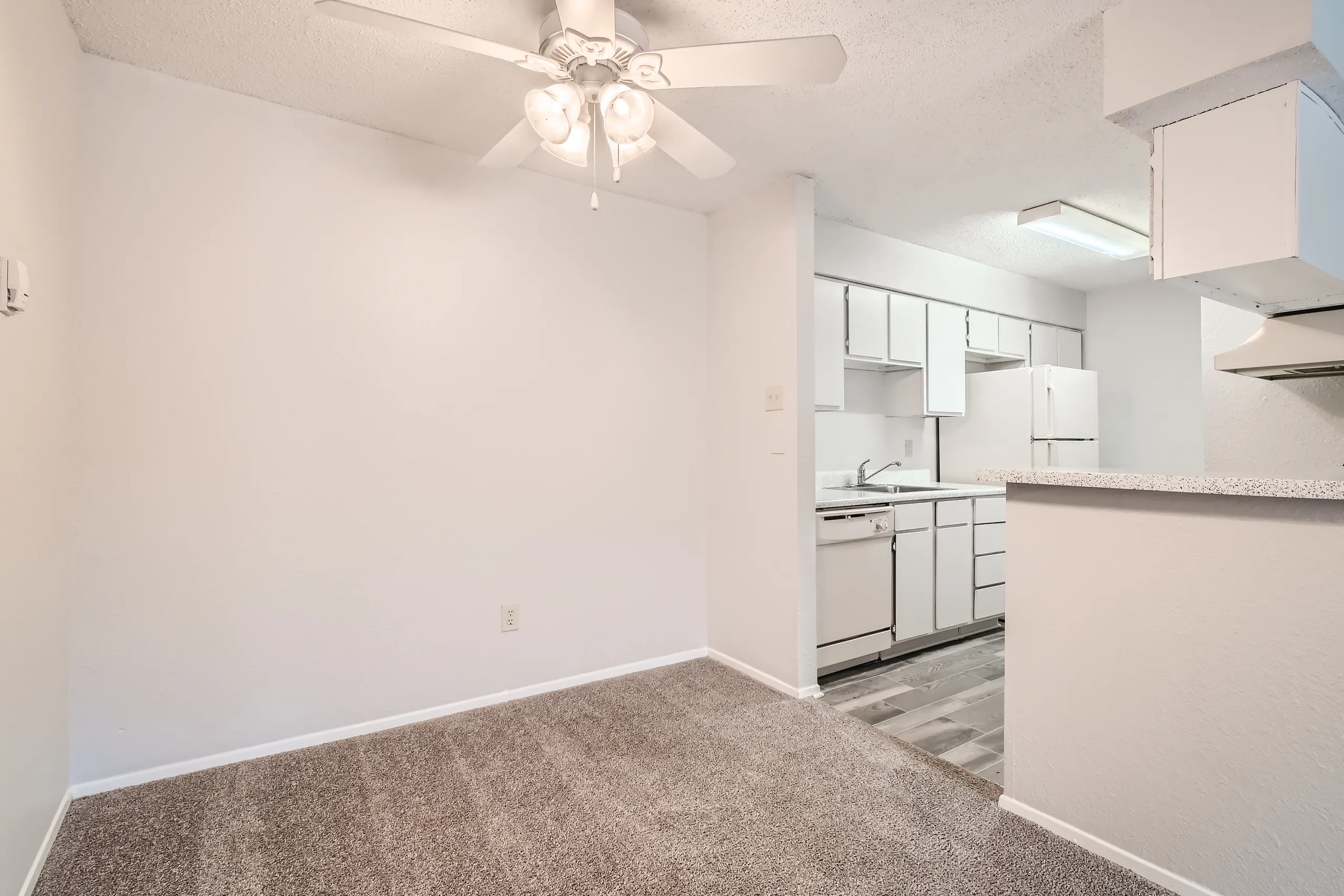 Dining area with ceiling fan and open view to kitchen