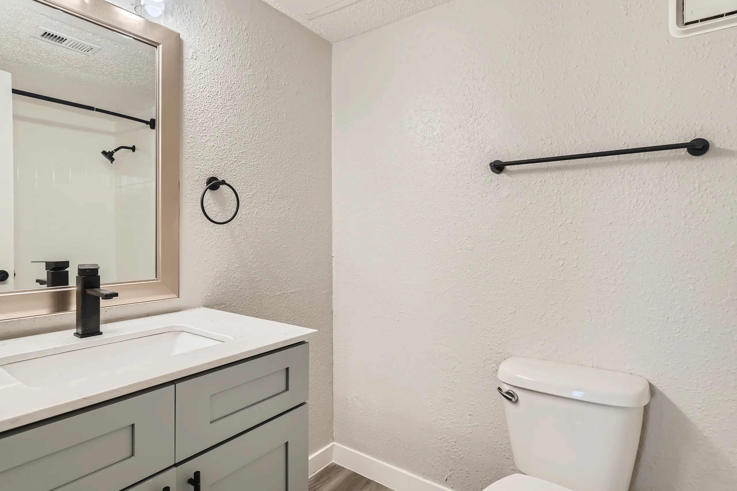 Primary bathroom with quartz vanity and tub shower combo