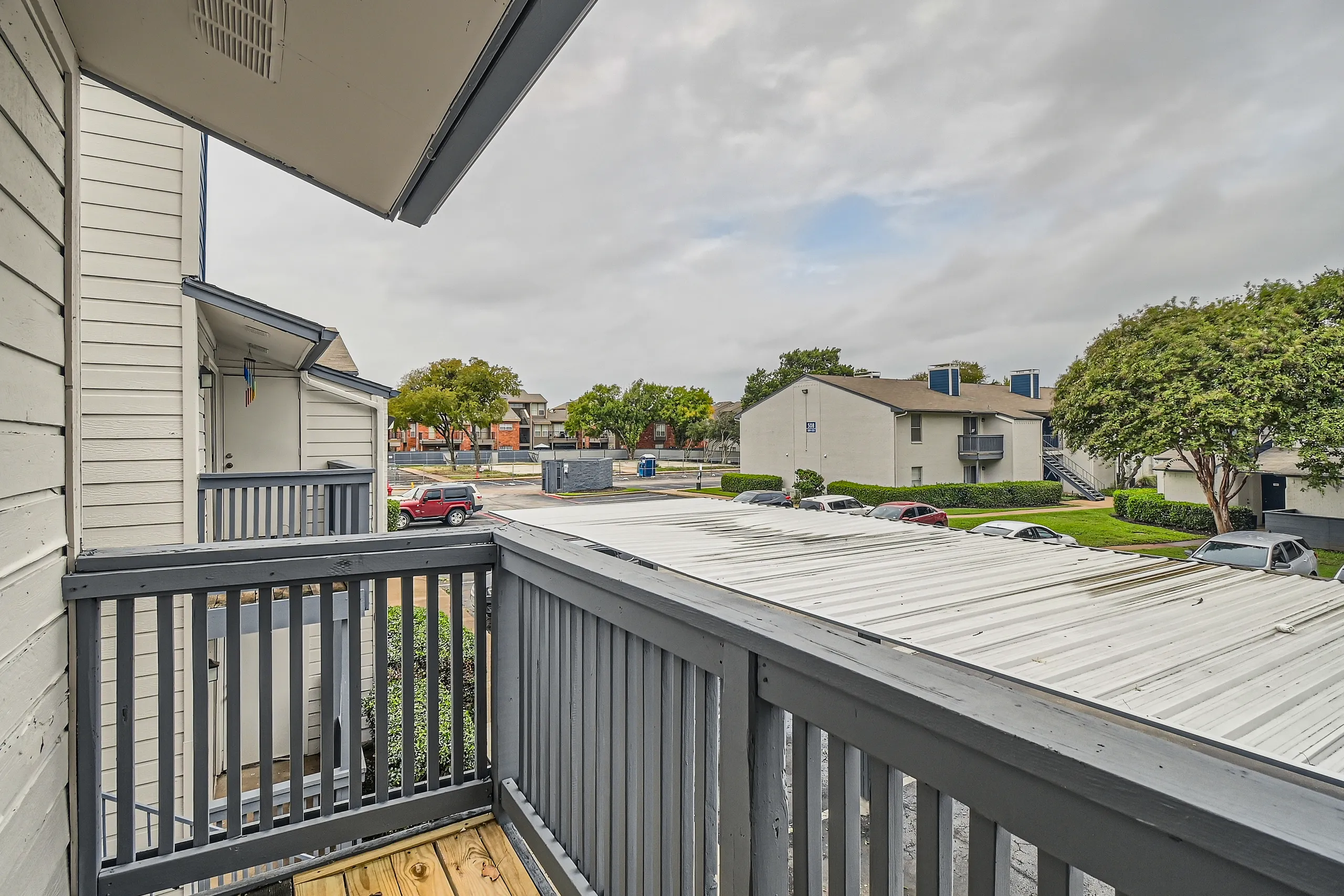 Private balcony with covered patio and courtyard view