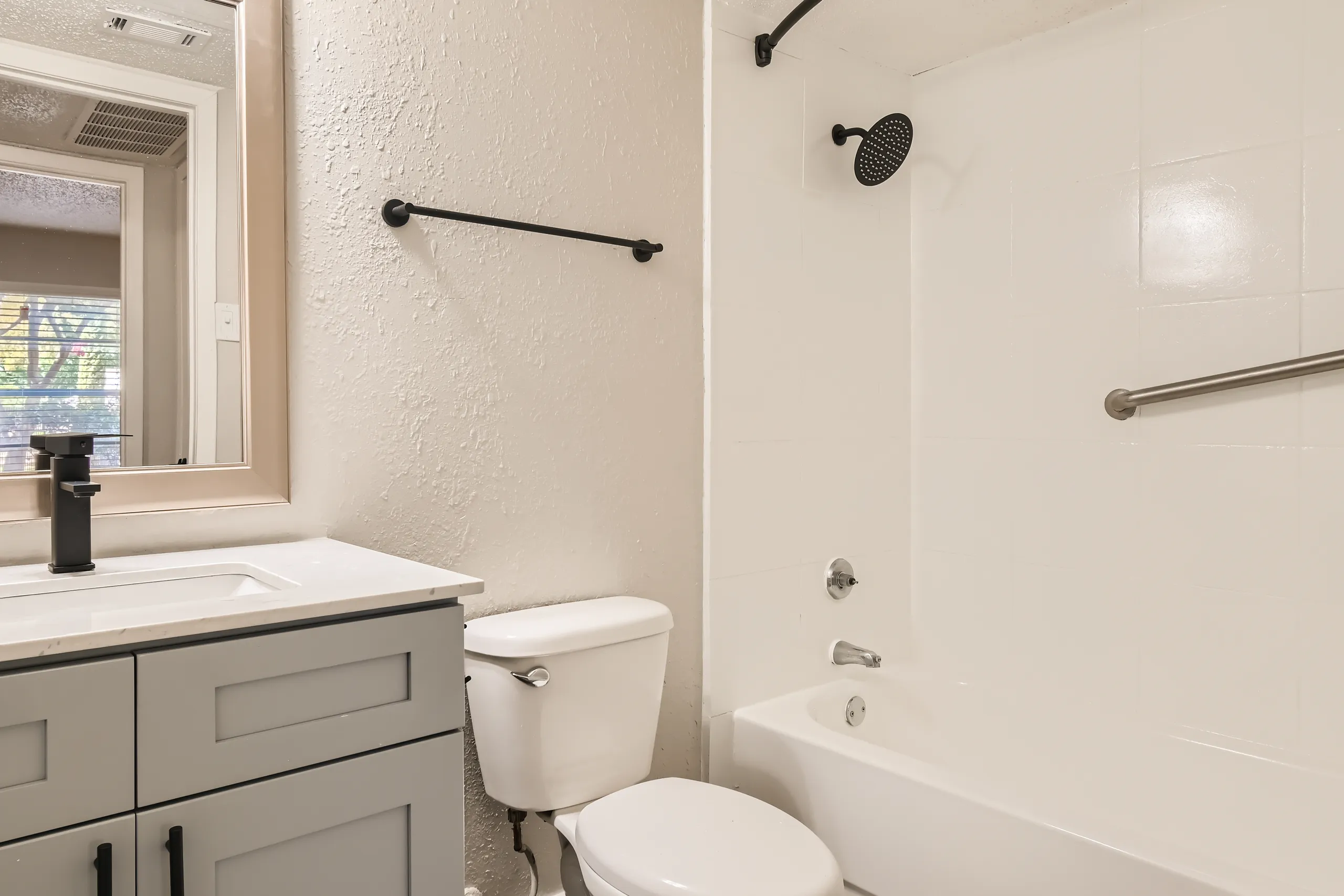 Primary bathroom with soaking tub and matte black fixtures