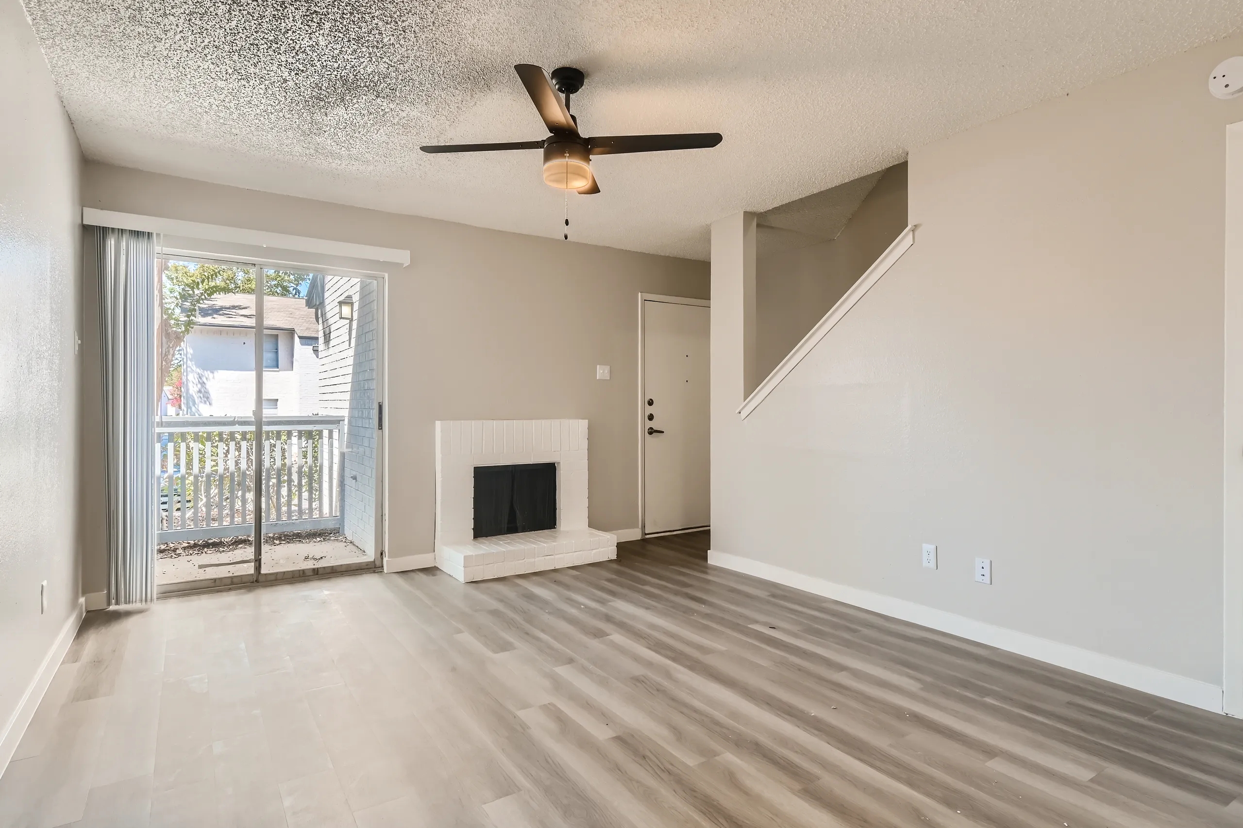 Living room with fireplace and sliding glass door