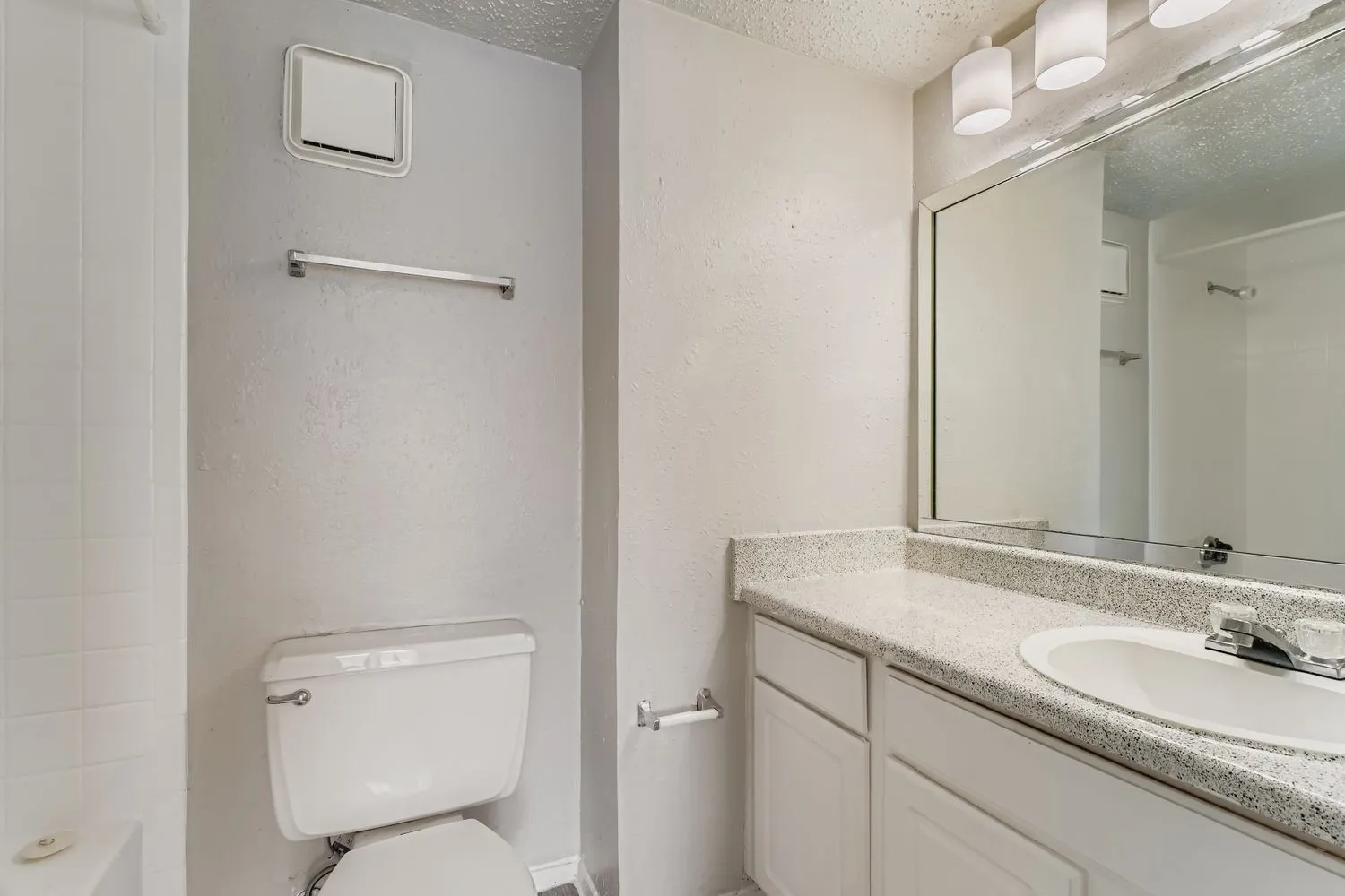 Vanity with granite counter, mirror, tub/shower combo