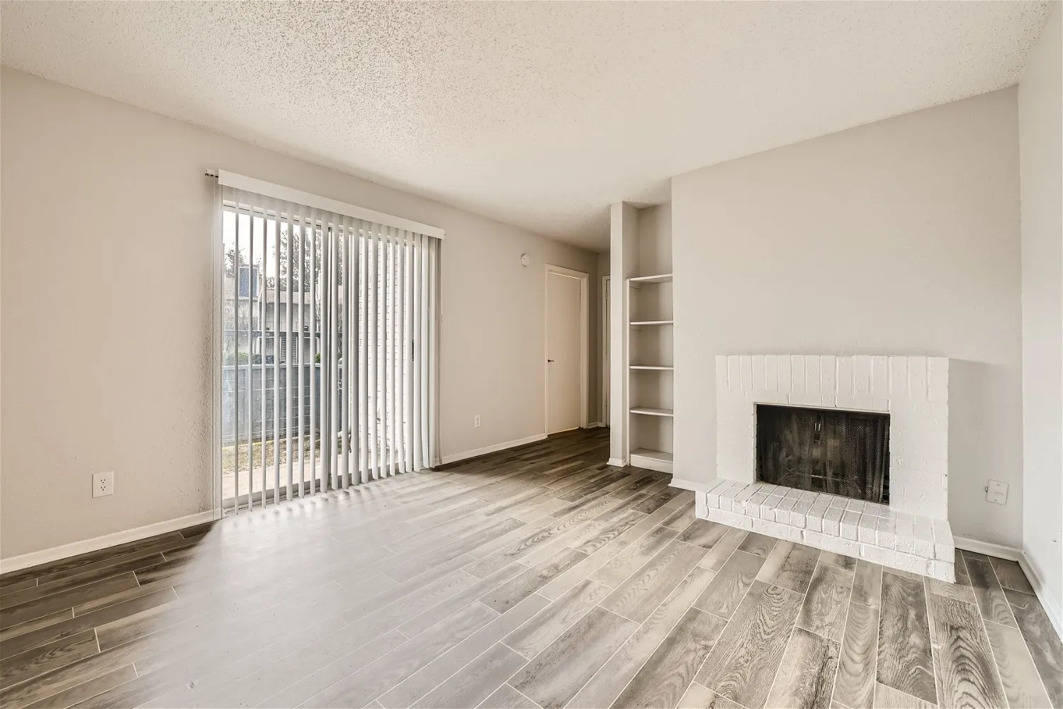 B1 Silver floor plan living room with painted brick fireplace and built-in shelving