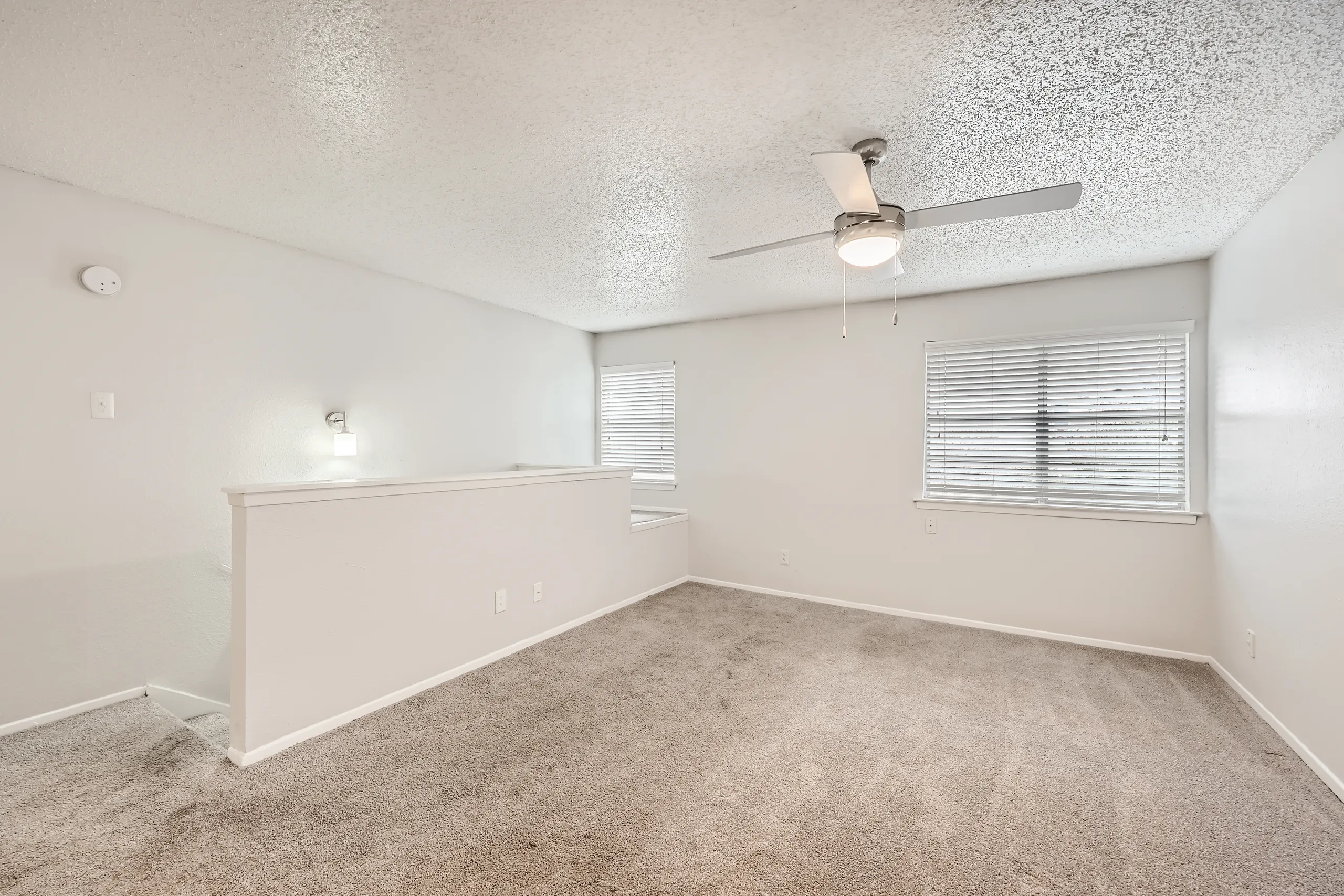 Second floor primary bedroom with ceiling fan and dual windows