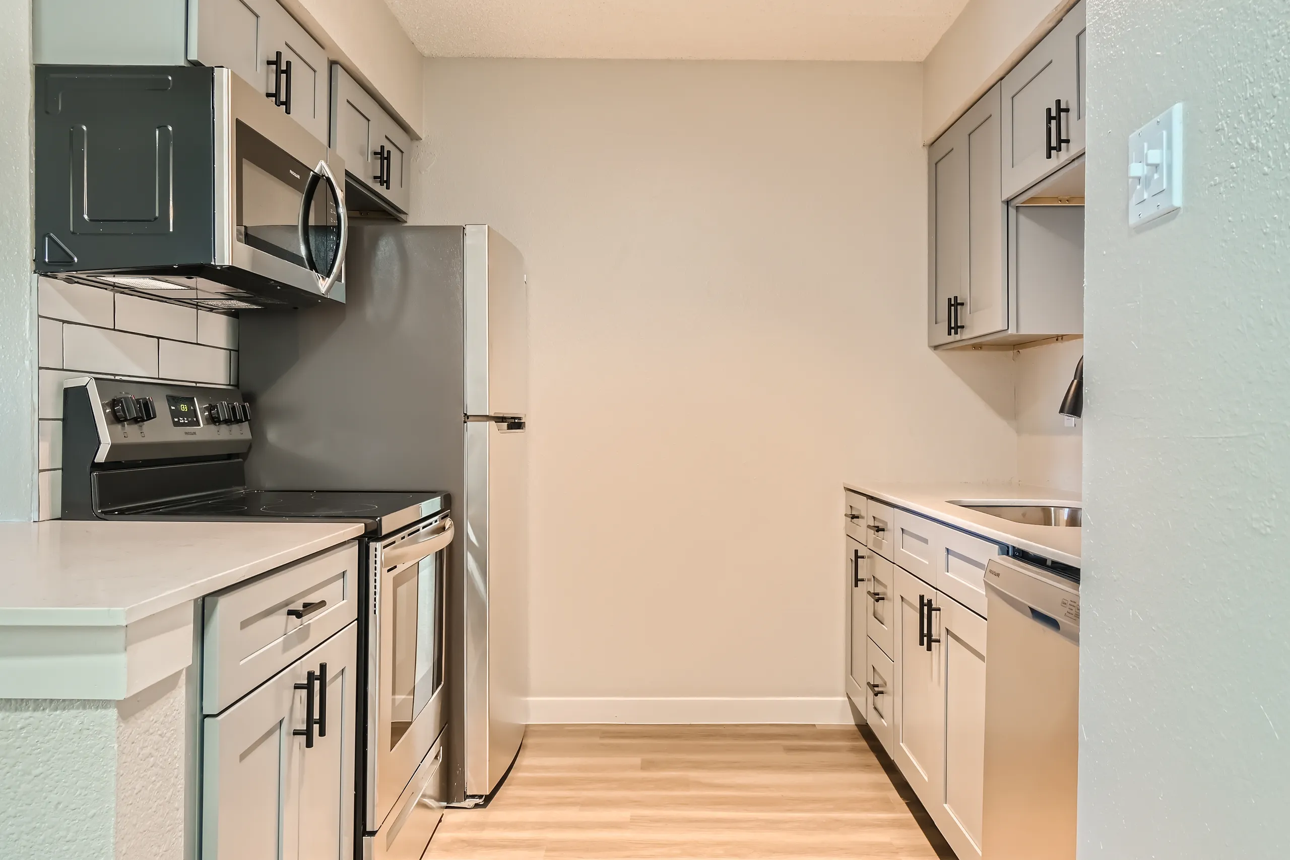 Kitchen with gray cabinetry and stainless steel appliances