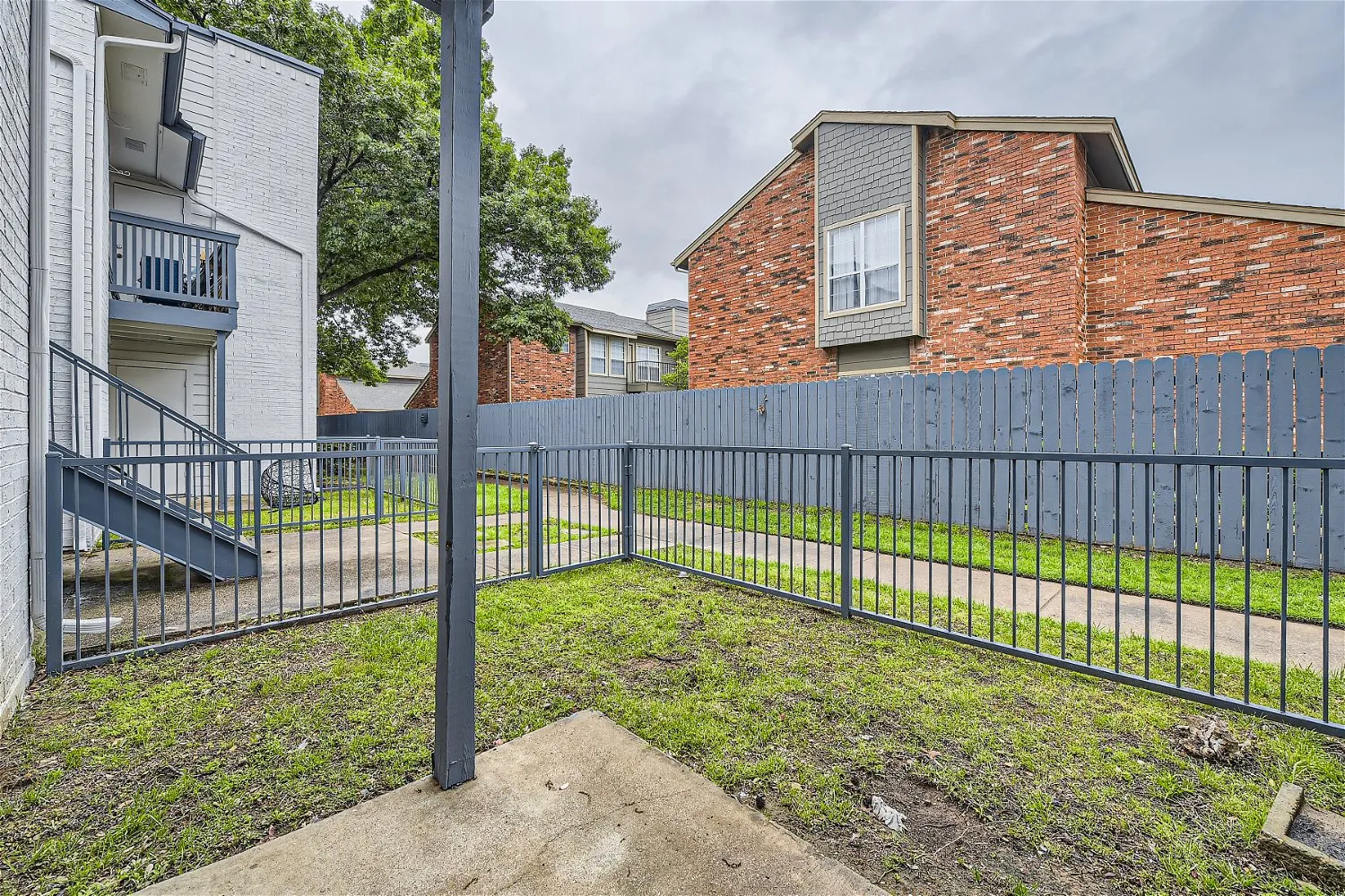 Private fenced patio with courtyard view