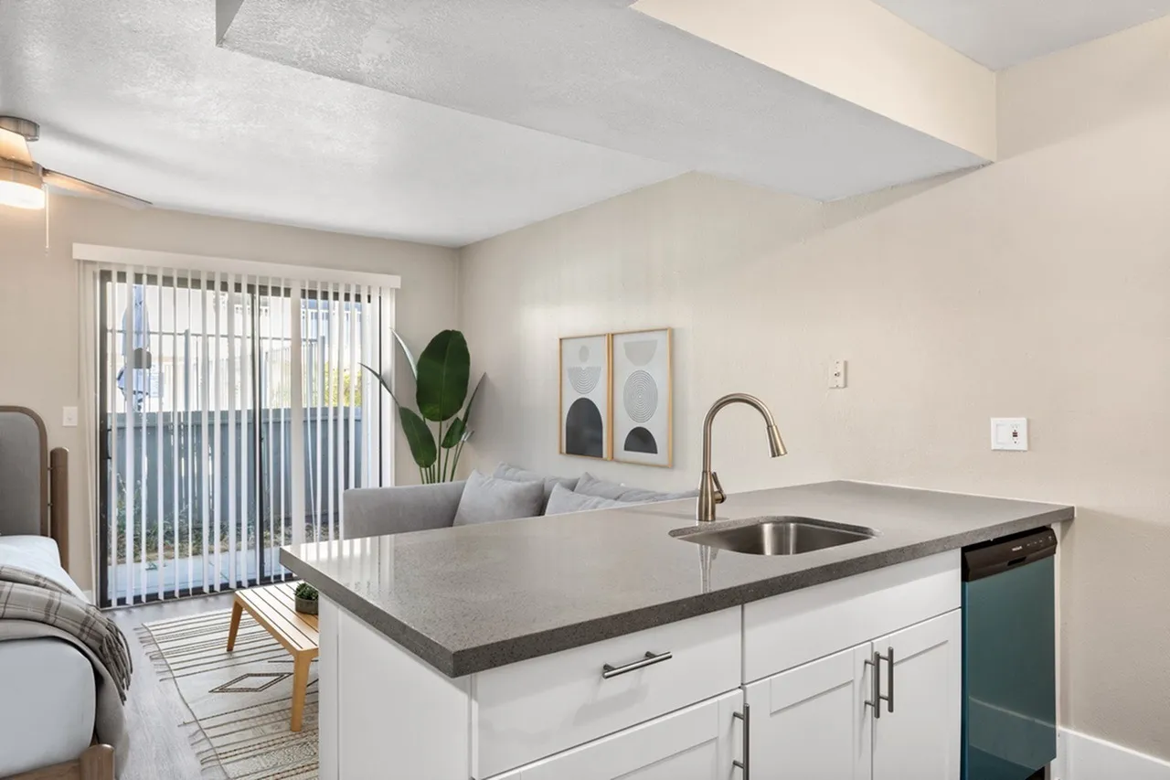 Kitchen, white shaker cabinetry, gray quartz countertops, stainless sink, glass door entry