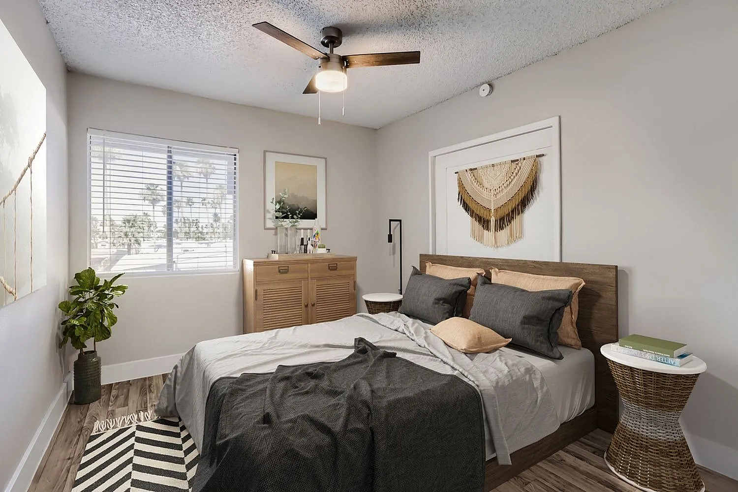 Primary bedroom, wood-style plank flooring, ceiling fan, wood bed frame, dark bedding
