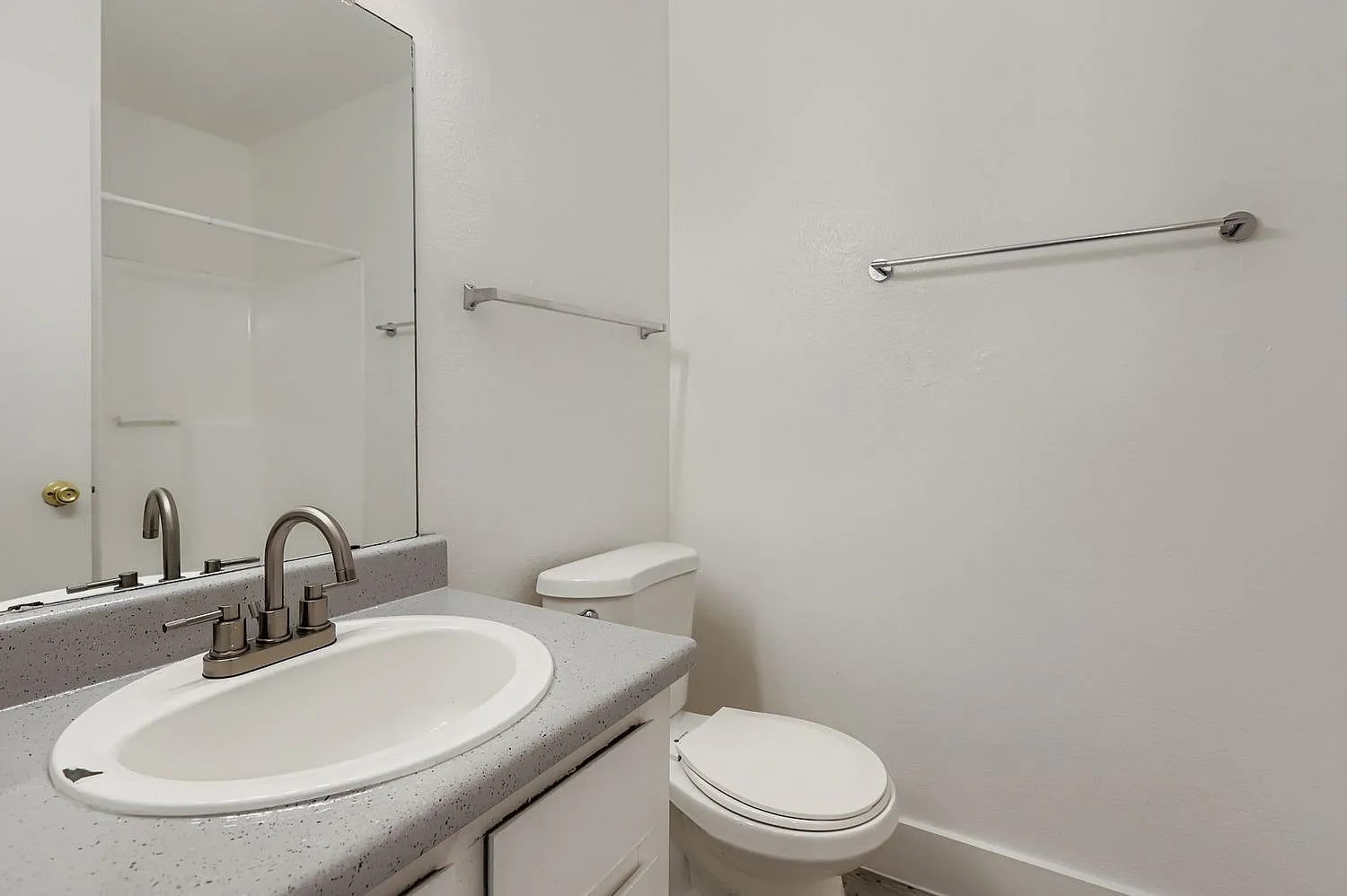 Bathroom, gray quartz vanity, oval white sink, brushed nickel faucet, white toilet
