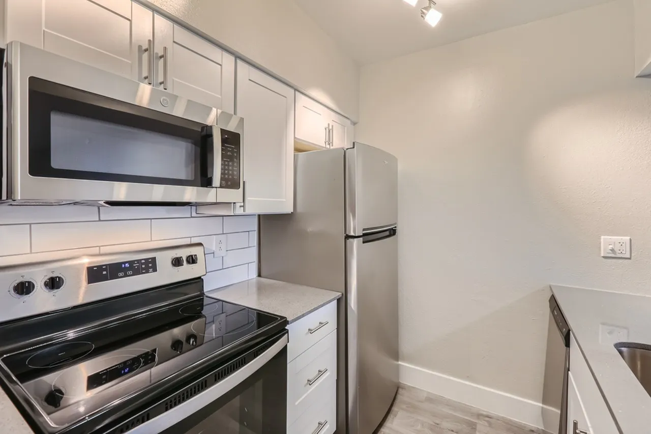 Kitchen, white shaker cabinetry, quartz countertops, stainless steel appliances, subway tile backsplash