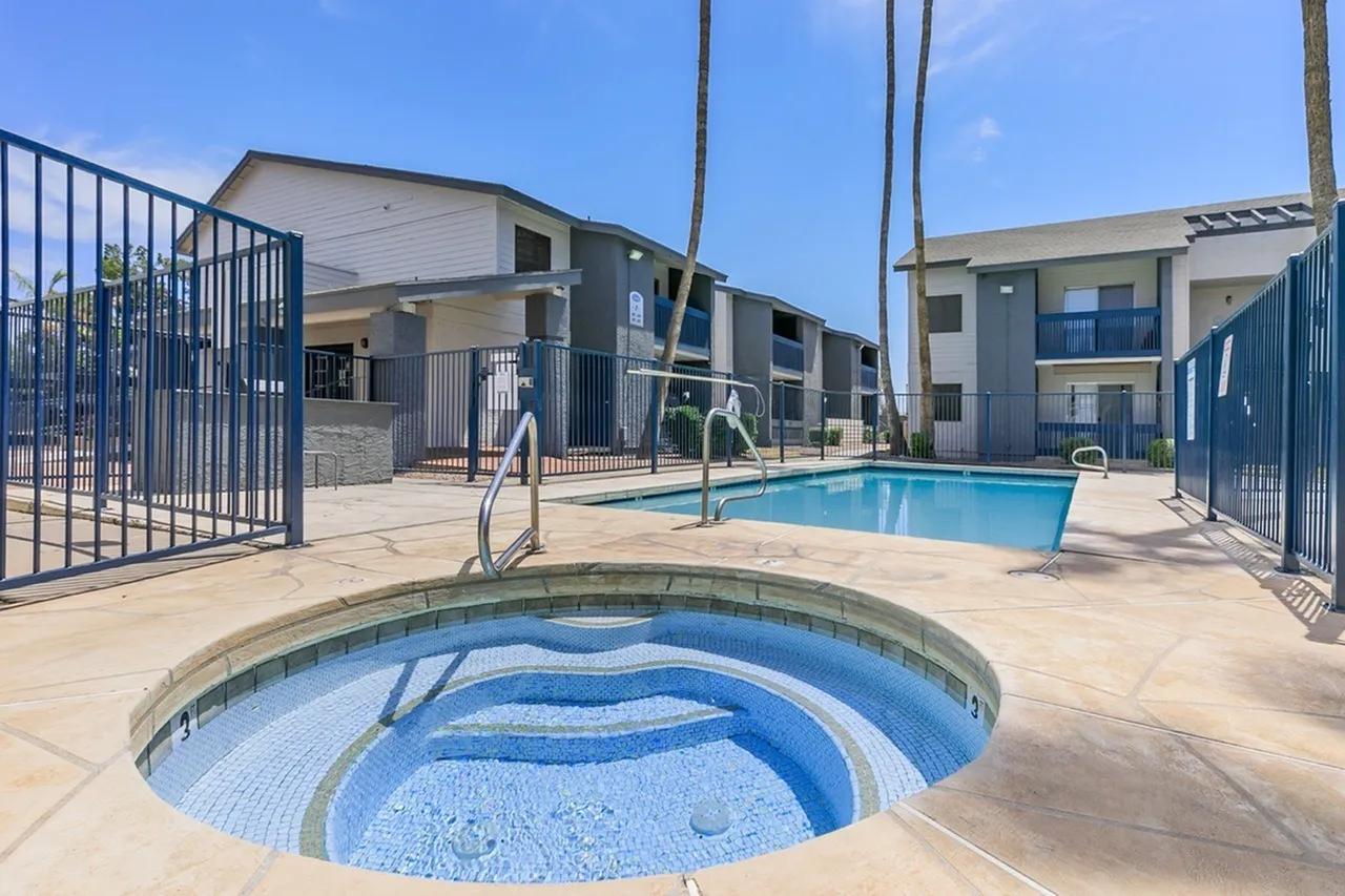 Pool and spa area, blue safety gates, resort-style lounging space, resort-style aqua features