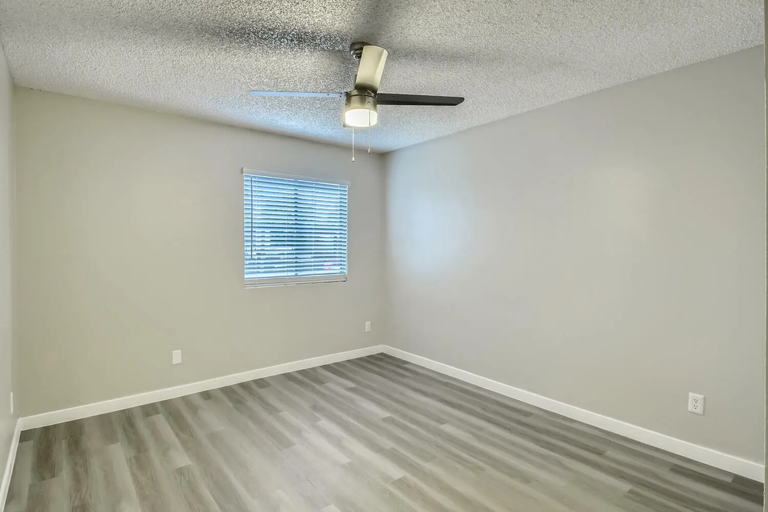 Bedroom, wood-style plank flooring, ceiling fan with light, blinds window