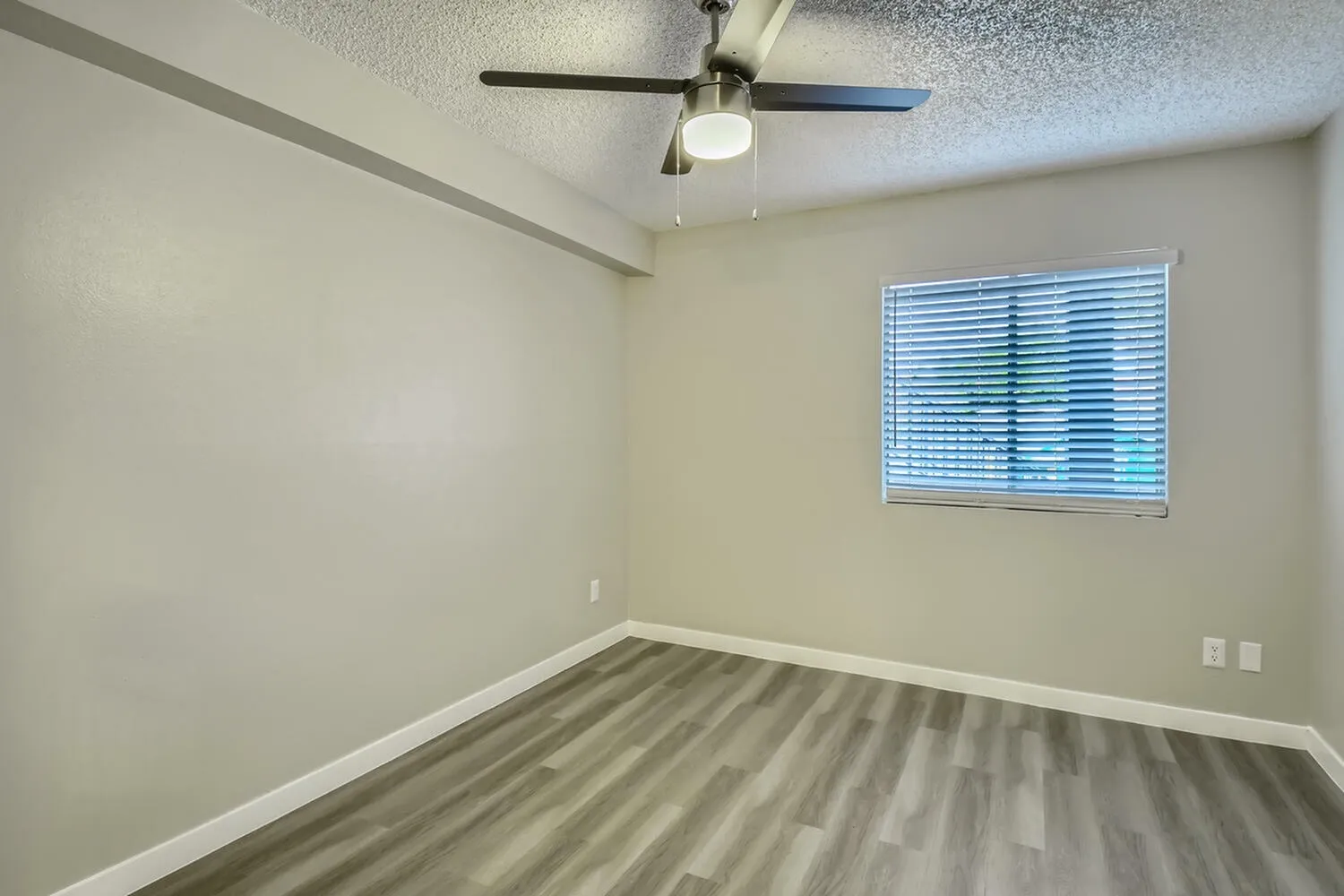Bedroom, wood-style plank flooring, ceiling fan with light, horizontal window blinds