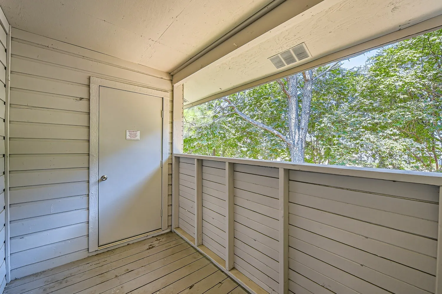Covered porch, wood-style plank flooring, horizontal siding railing, open view