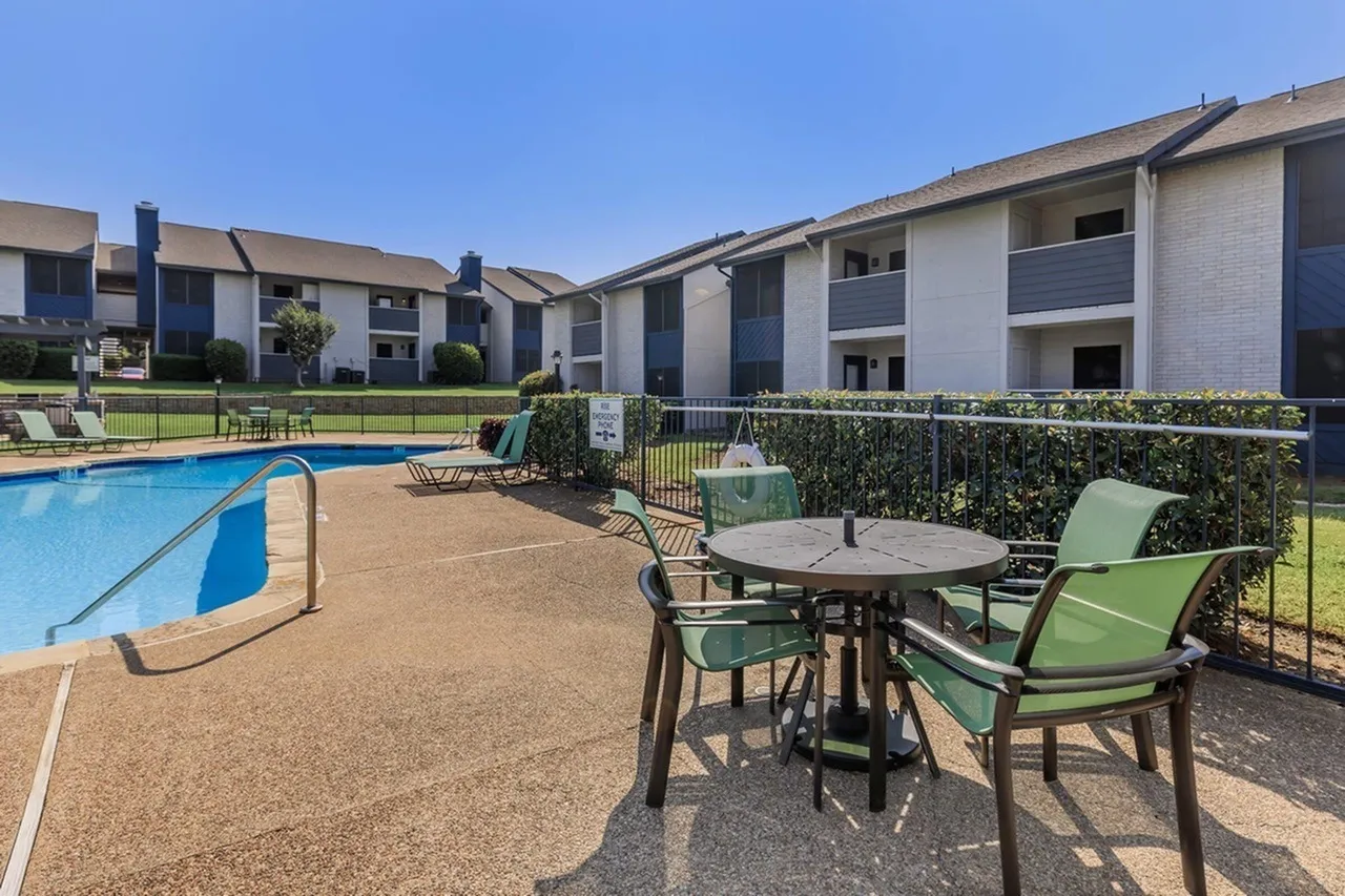 Pool area, lounge chairs, round patio table, green chairs, landscaping