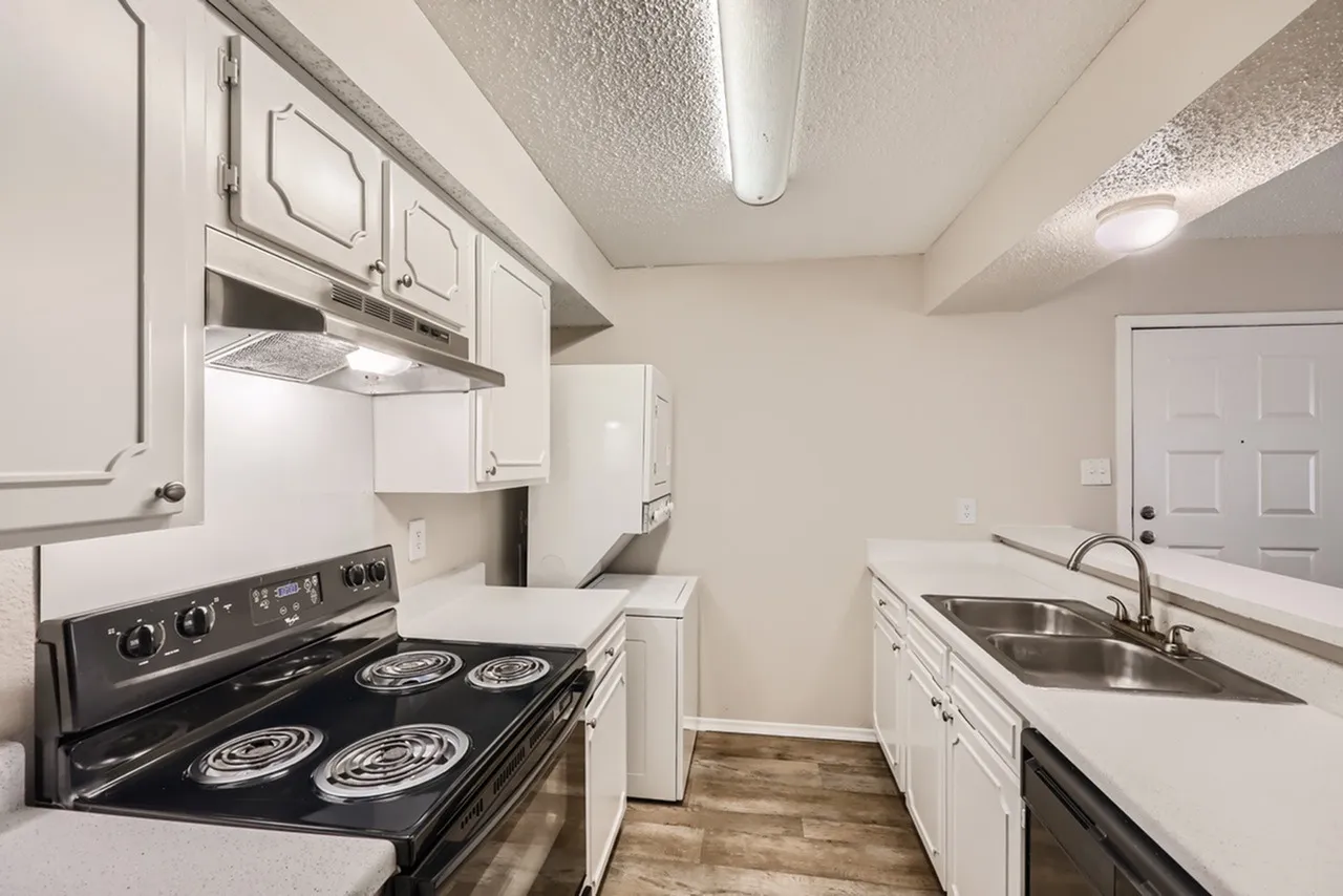 Kitchen, white cabinetry, black electric range, stainless sink, wood-style plank flooring