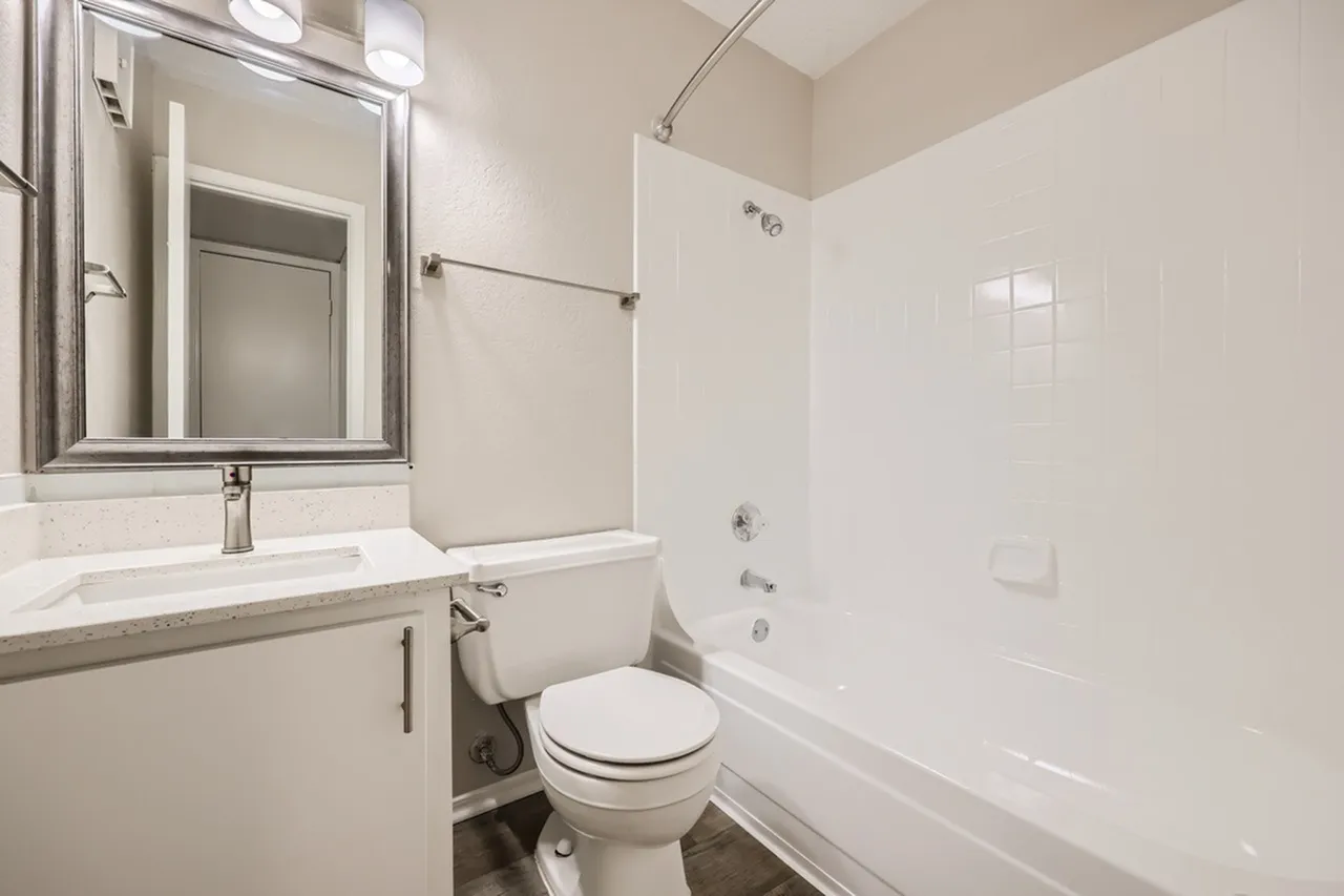 Bathroom, floating vanity with quartz countertop, mirror cabinet, white subway tile, bathtub