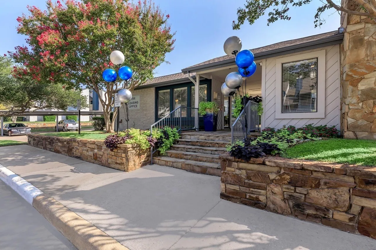 Front entrance, stone planter, blue and white balloons, blooming crepe myrtle, porch, stone exterior