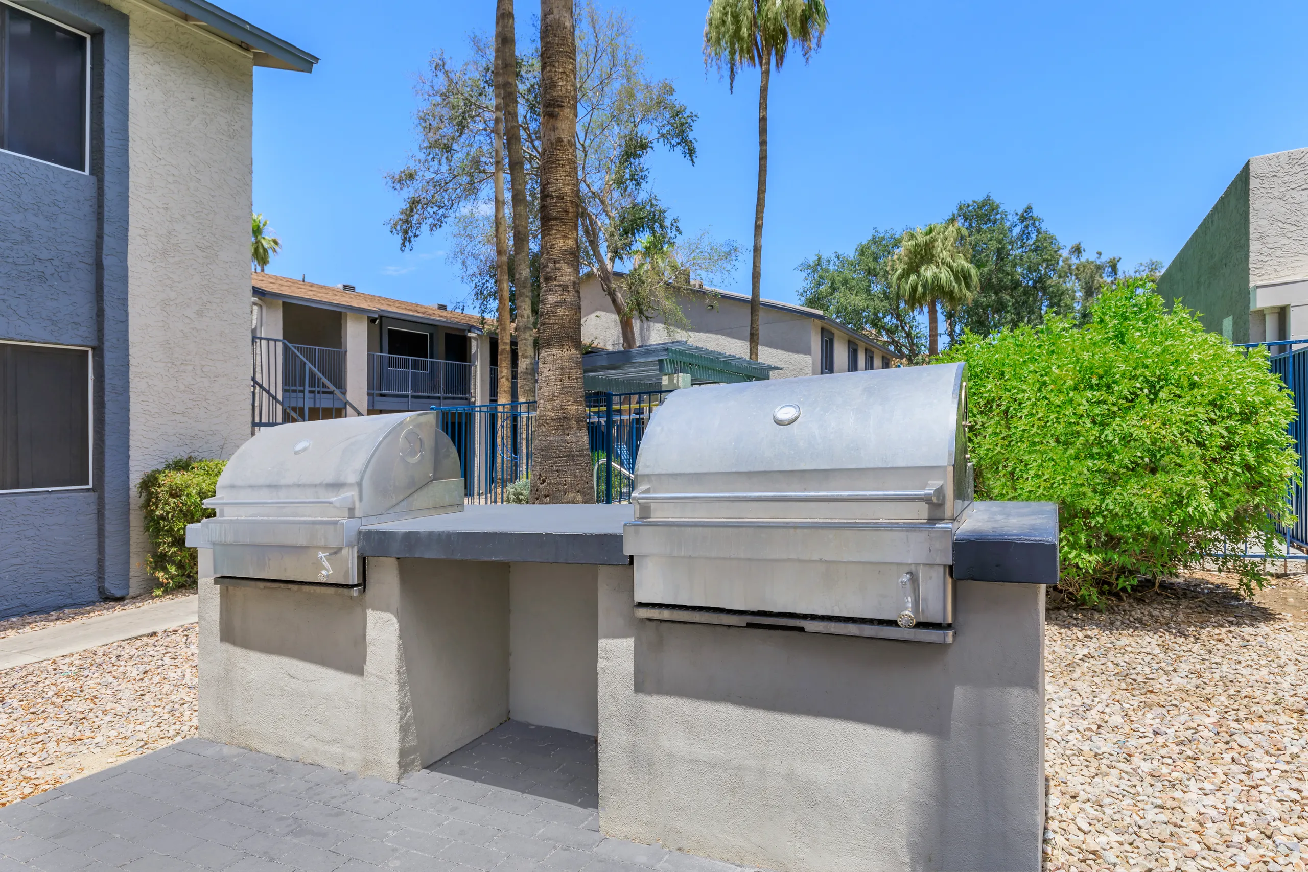 Outdoor grilling station with two stainless steel barbecues