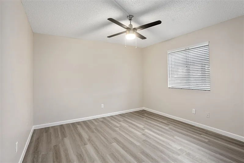Bedroom with ceiling fan and window