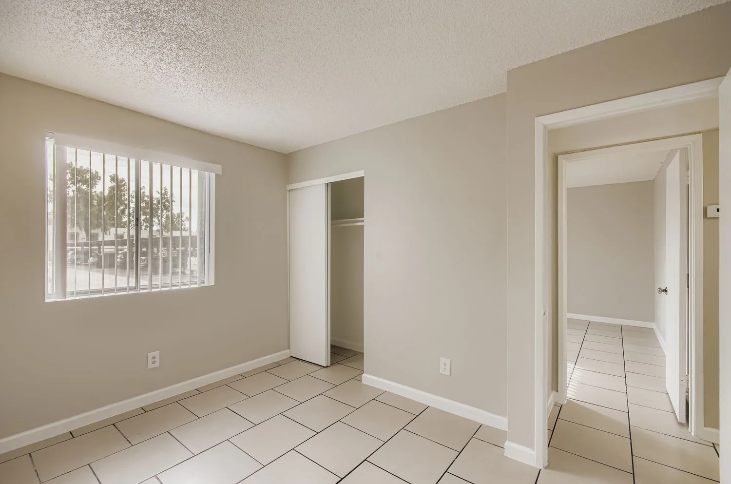 Bedroom with closet and view into hallway