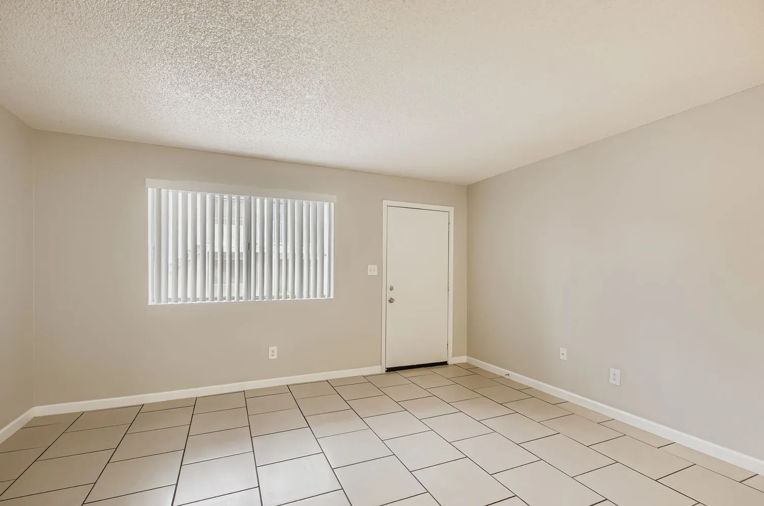 Living room with vertical blinds and exterior entry door