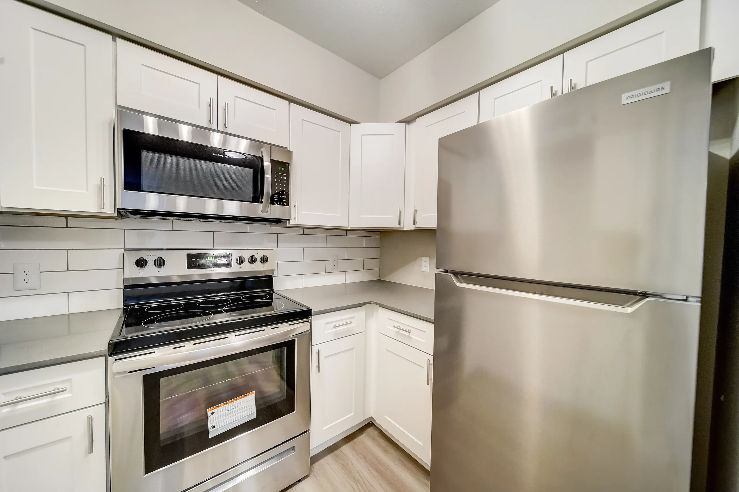 Kitchen with white cabinetry and stainless steel appliances