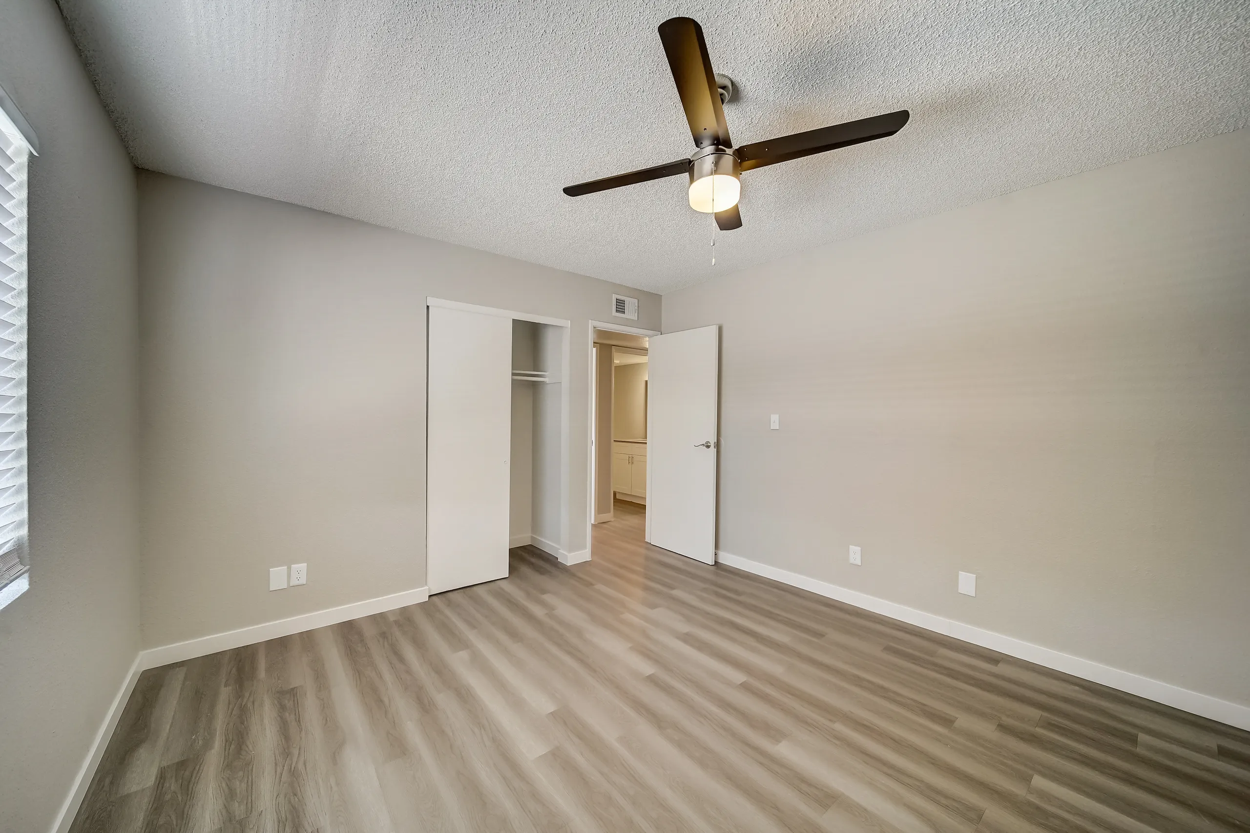Bedroom with closet and view into hallway bathroom