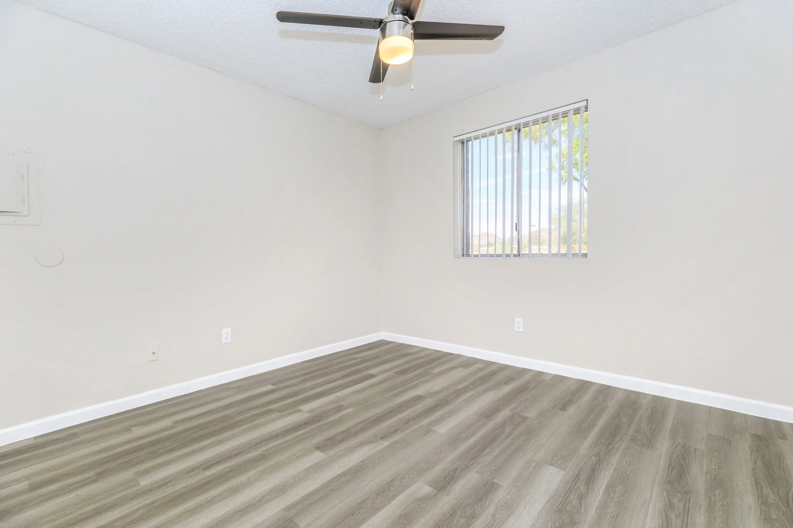 Bedroom with ceiling fan and vertical blinds