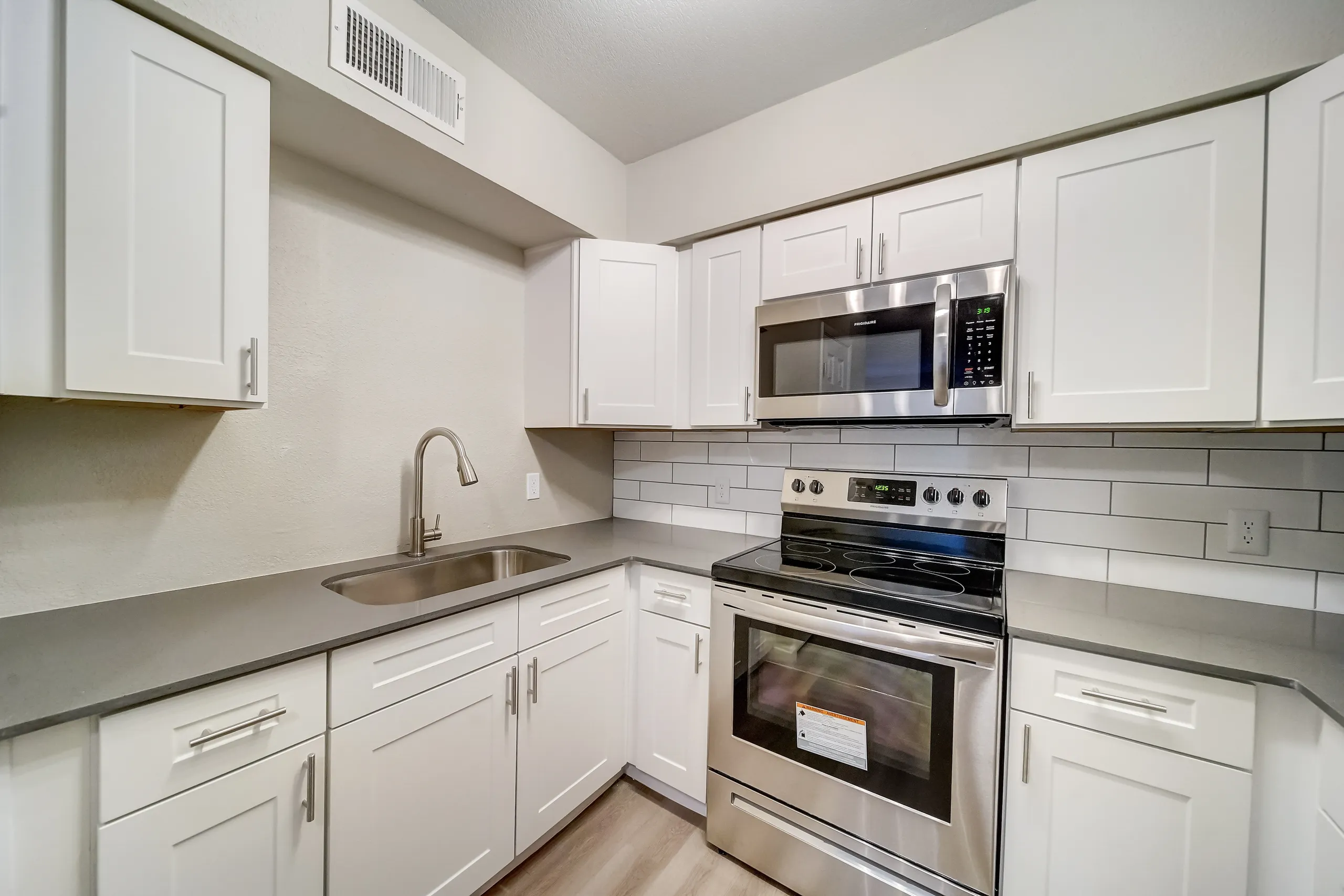 Kitchen with stainless steel appliances and subway tile backsplash