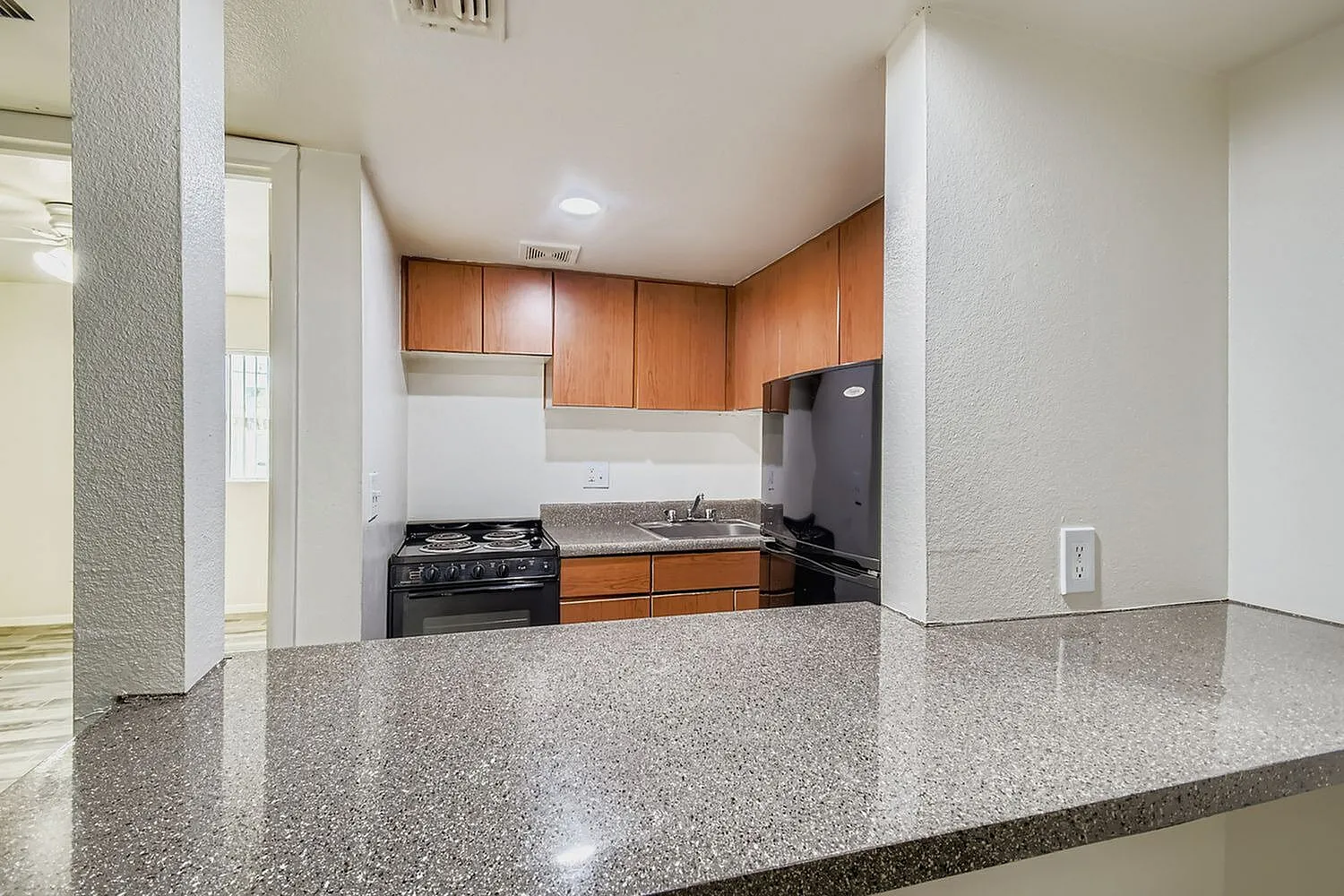 Kitchen, wood cabinetry, granite countertops, black gas range, black refrigerator