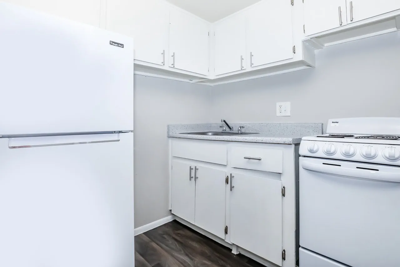 Kitchen, white shaker cabinetry, laminate countertops, stainless appliances, wood-style plank flooring
