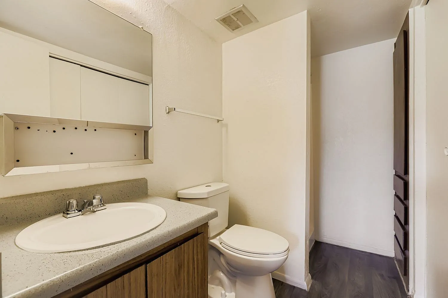 Bathroom, round white sink, concrete countertop, wood vanity, toilet